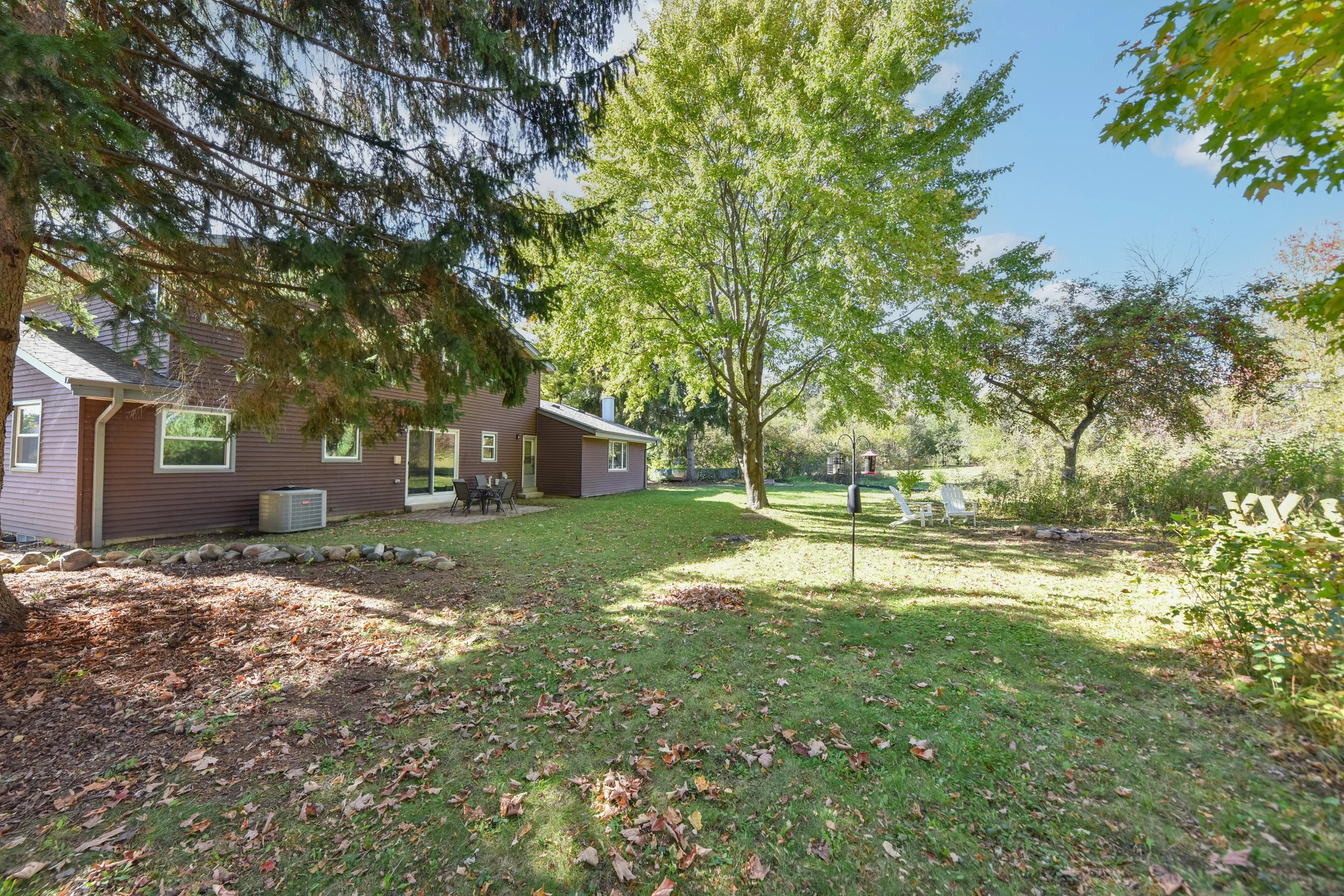 fenced in, tree-lined yard