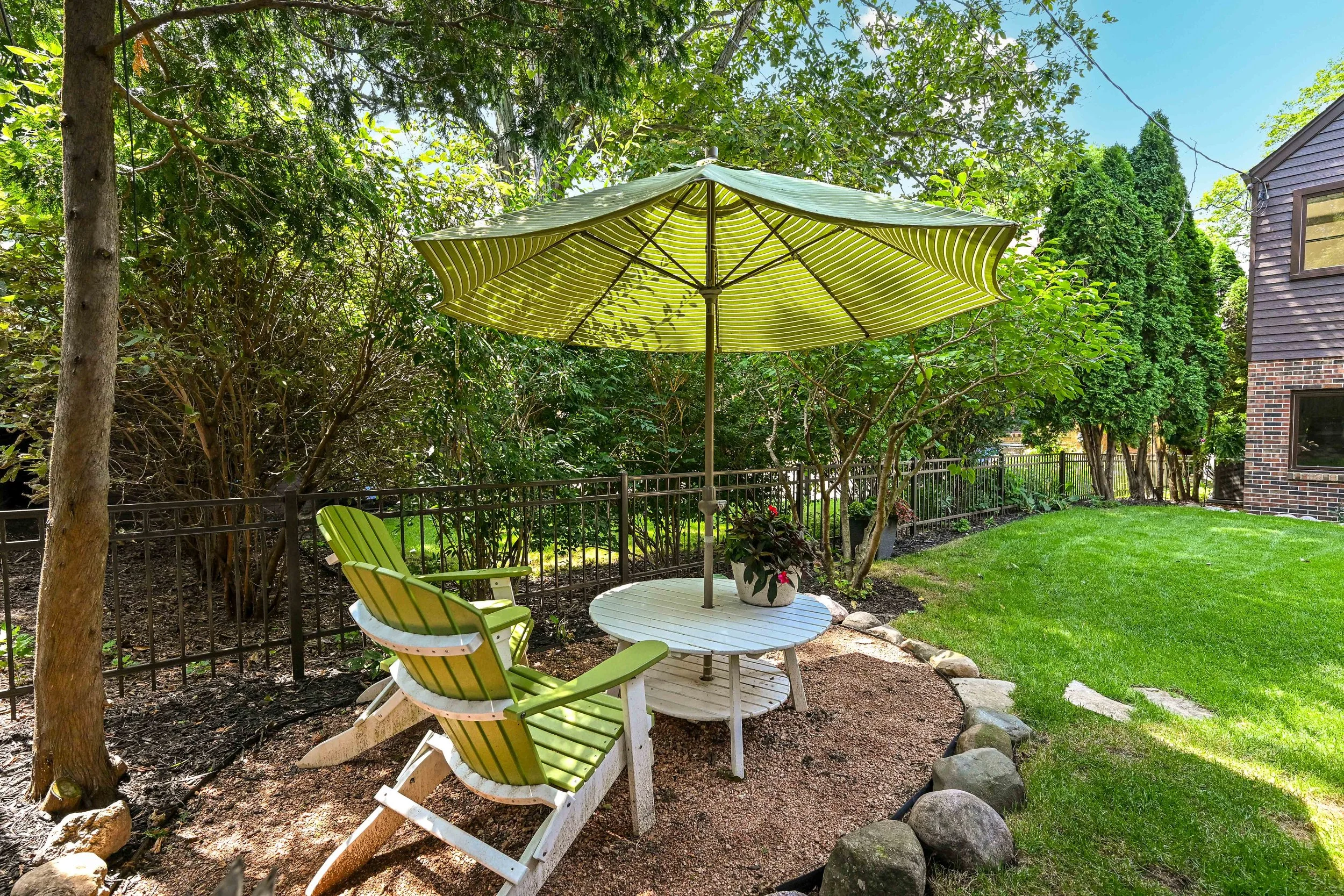 fenced in, tree-lined yard