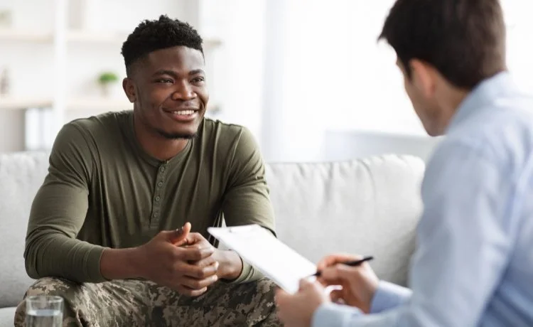 A male service member speaking with a psychiatrist about TRICARE medication management near Las Vegas, Nevada.