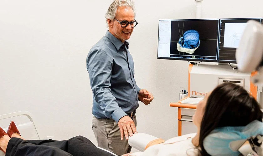 Dr. Reitano speaking with a patient about TMS therapy for PTSD near Charleston Heights, Las Vegas, Nevada.