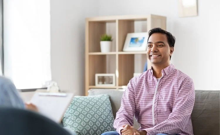 A male patient on couch doing psychotherapy, one of the Historic Westside, Las Vegas behavioral health treatments available at Delve Psychiatry.