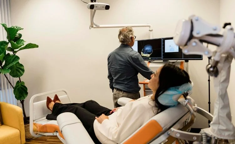 A female patient starting a TMS session for her Boulder City OCD psychiatric therapy.