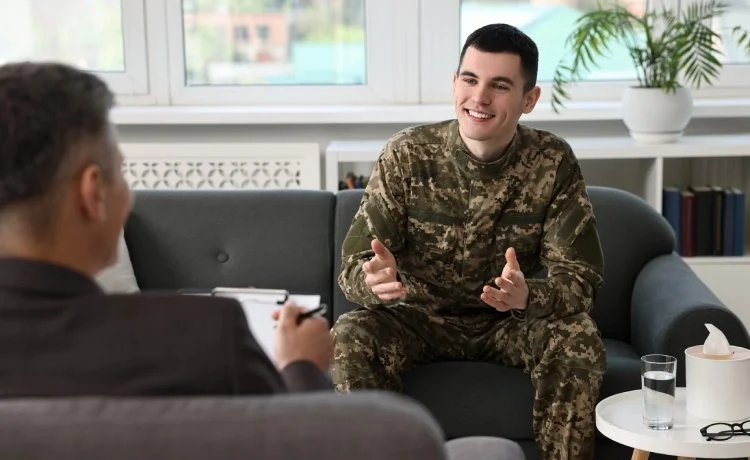 A service member on a couch talking to our TRICARE psychiatrist near Henderson, Nevada.