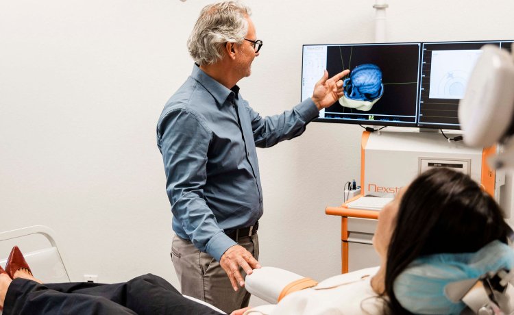 Dr. John Reitano, a trusted Henderson psychiatrist, administering a TMS treatment.