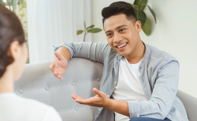A happy male patient on couch talking to the top psychiatrist near Blue Diamond, NV.