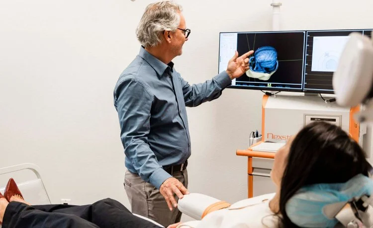 Dr. John Reitano, a trusted Blue Diamond psychiatrist, administering a TMS treatment.