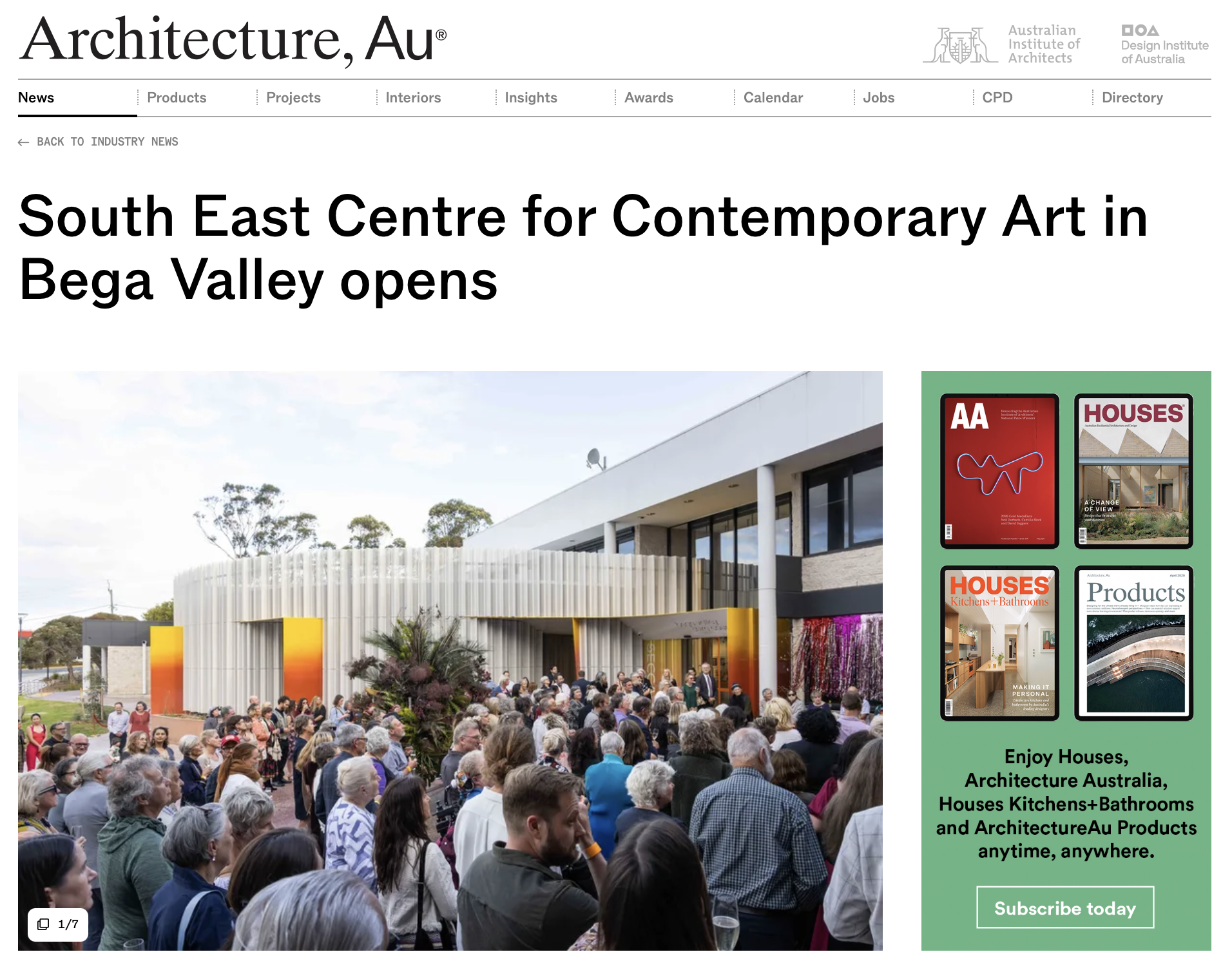 A crowd gathered outside a modern building at an opening event for the South East Centre for Contemporary Art in Bega Valley, Australia, with people listening to a speaker and observing the architecture.