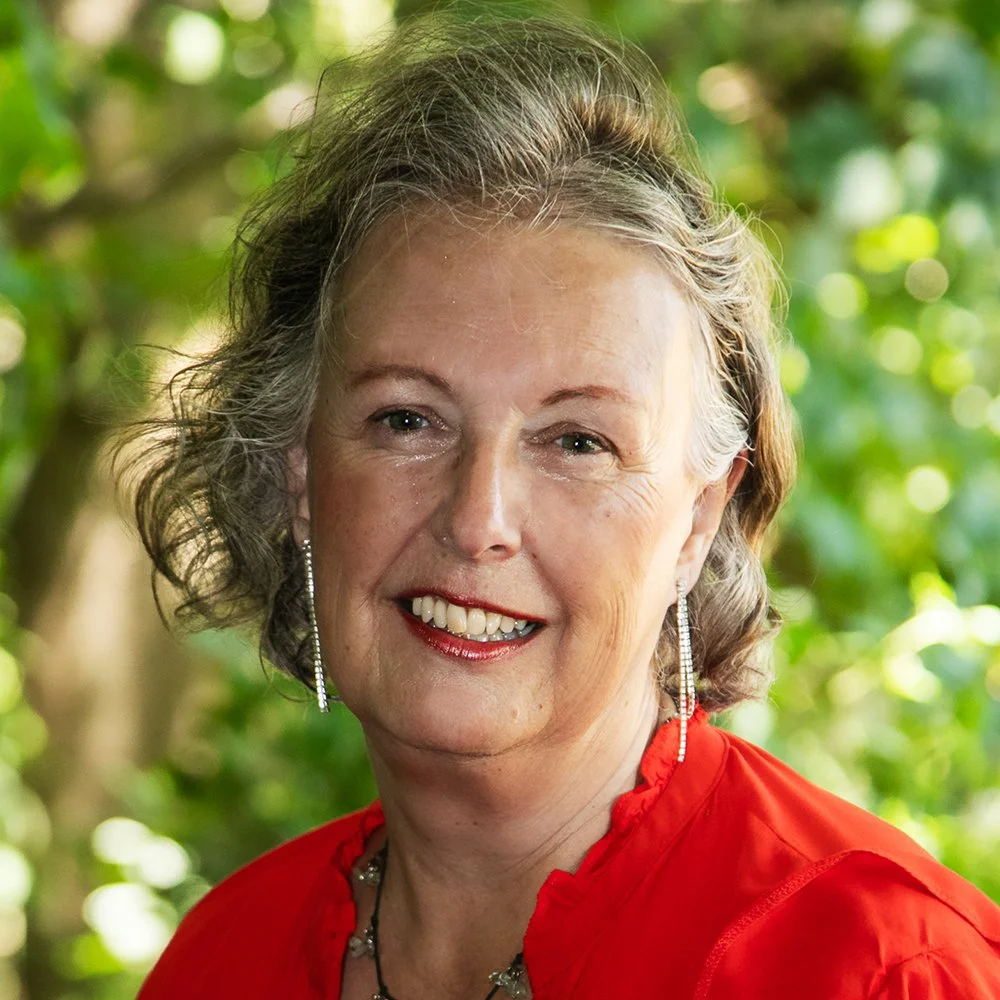 Karen smiling,confident despite being too hot. , wearing a red blouse.