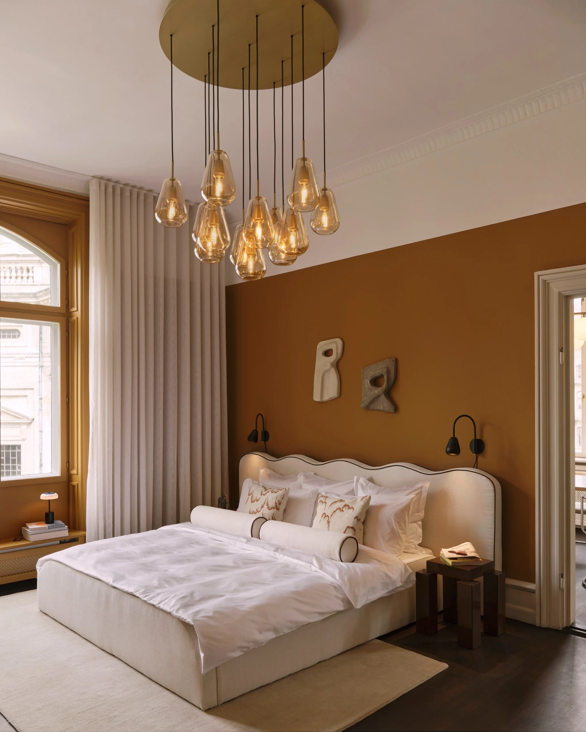 Nuura Anoli ambra colored glass pendant, can be a single pendant or cluster, also available as metal wall lamp for hotel room 