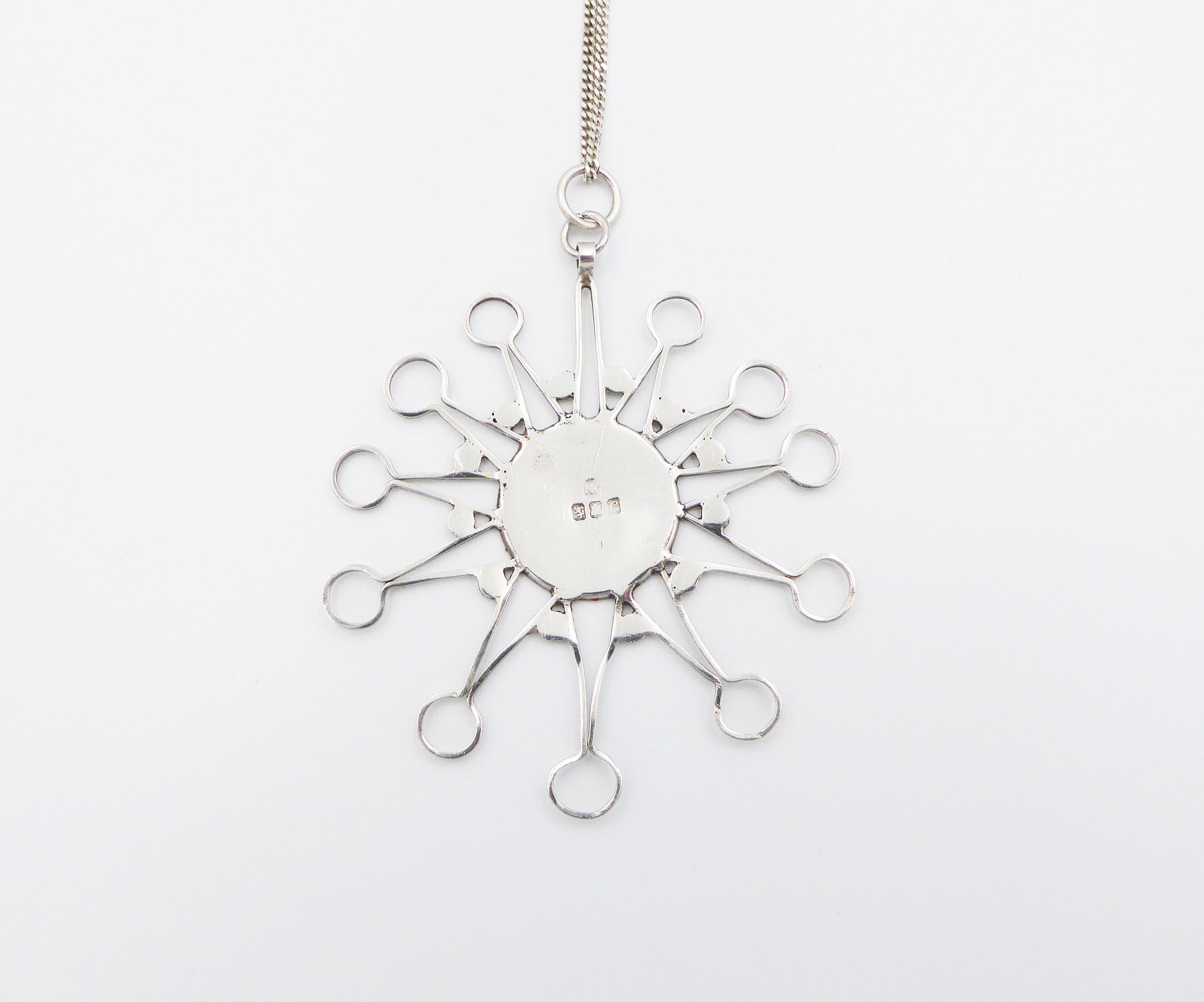 Silver and enamel starburst pendant and chain by Norman Grant (1943-2017), hallmarked Edinburgh, 1977 - reverse