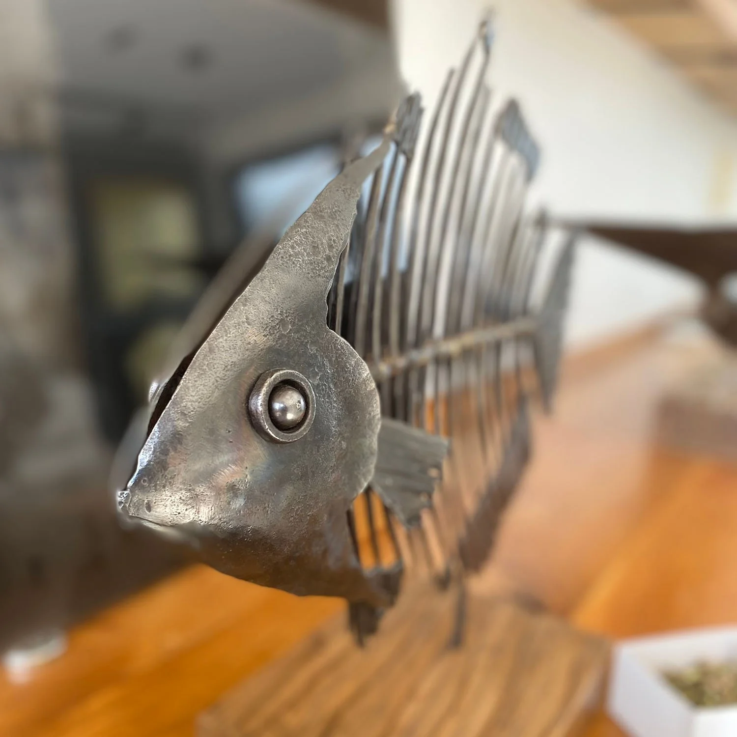 Close-up of a metallic sculpture of a fish skeleton