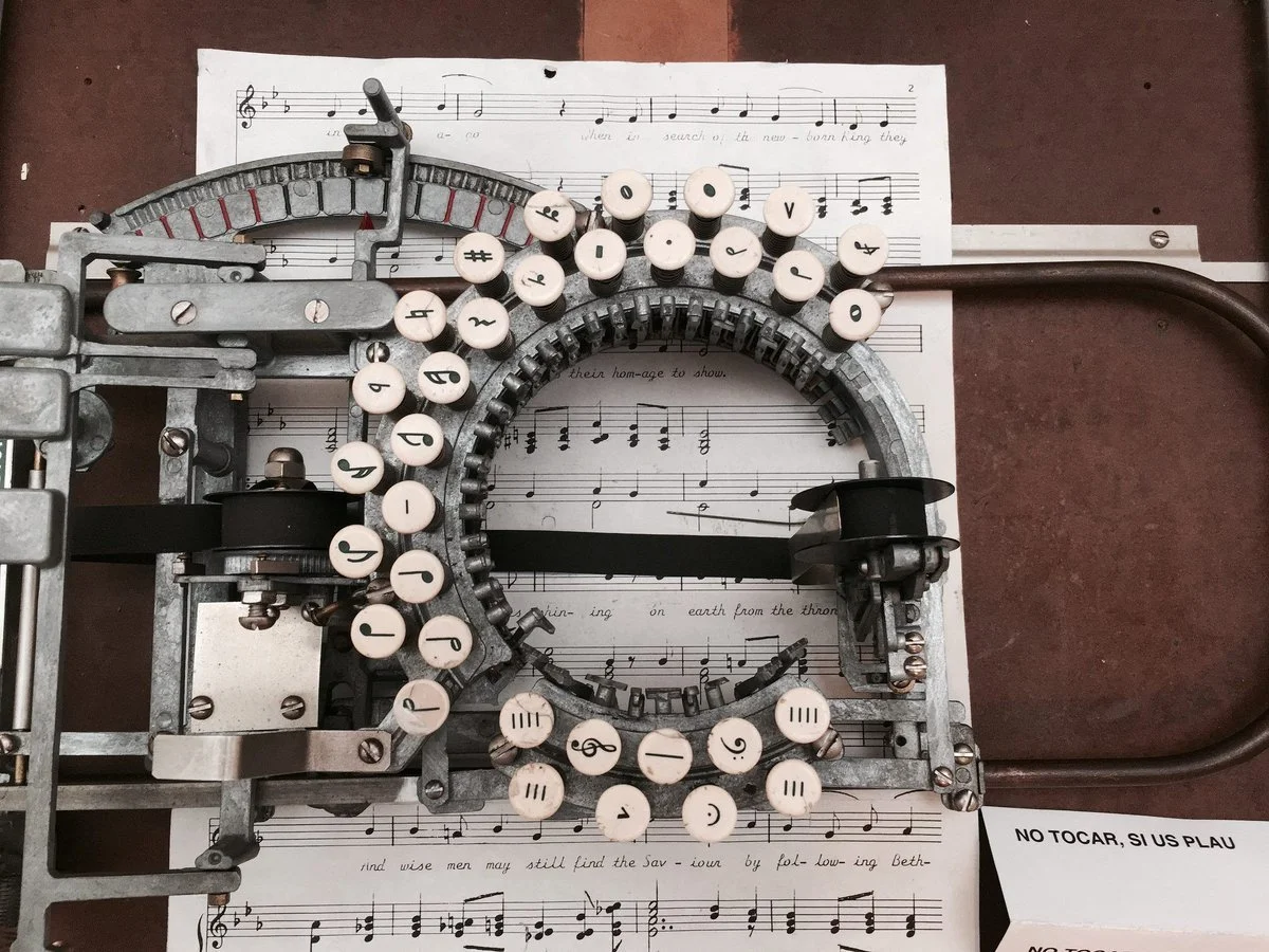 A music typing machine on a sheet music with small notes