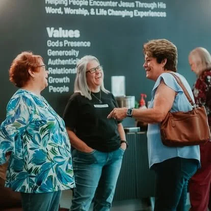 Picture of adults praying for one another