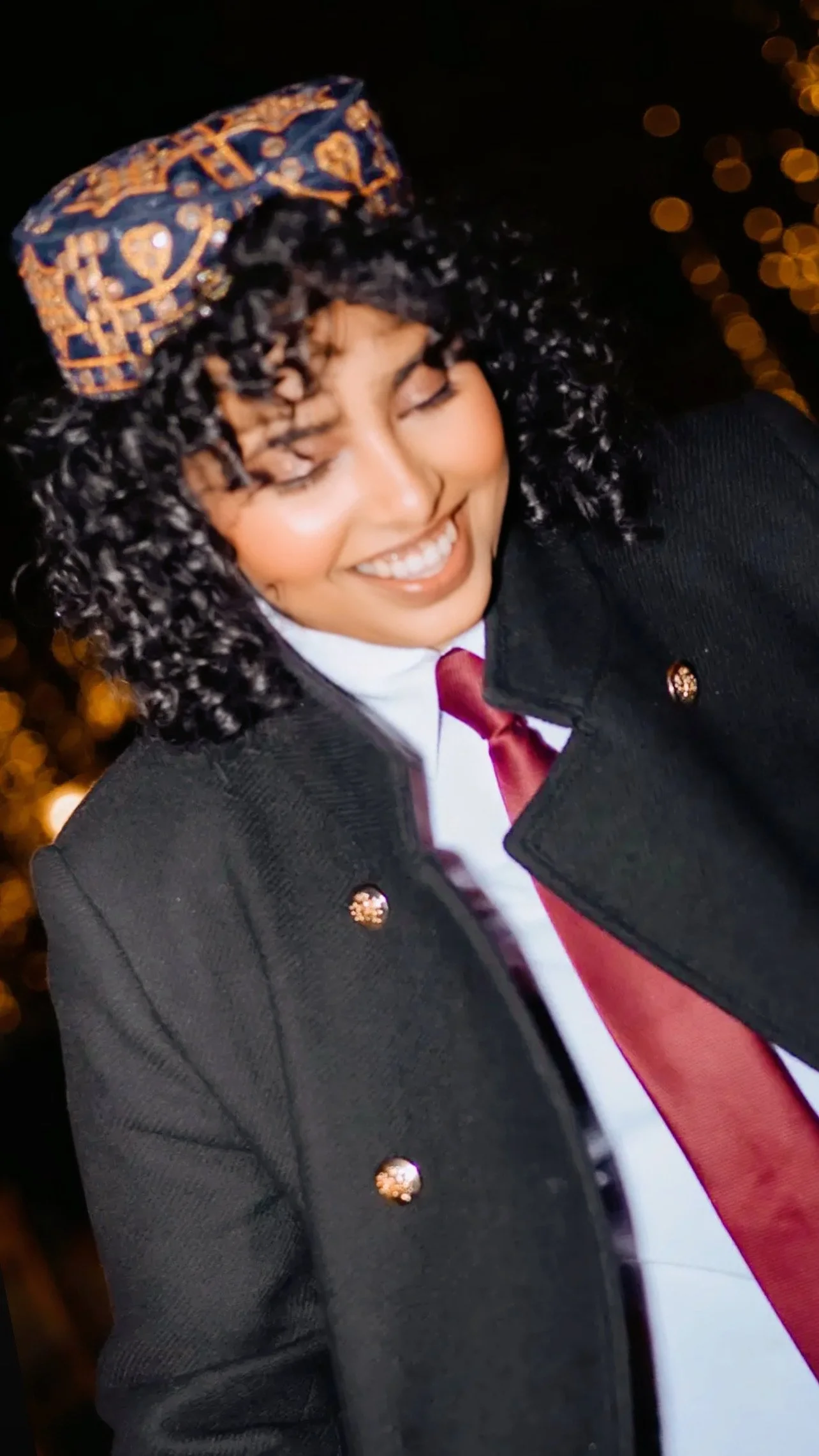 CEO of The Blue Soul Ashveta Budhrani with Sindhi Cap White Shirt Red Tie and Jacket, embracing her roots and futuristic thinking