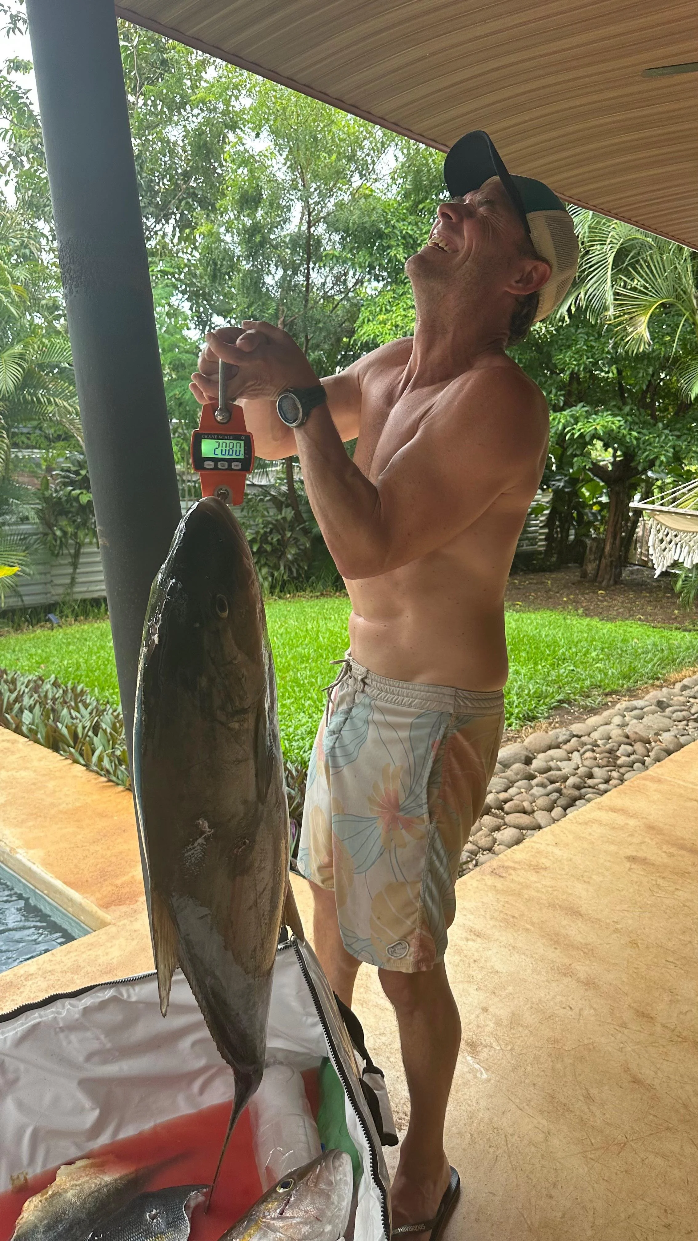 Spearfishing guide on Altum's boat the Sick Love on an open spearfishing tour in Flamingo Bay, Costa Rica holding a freshly caught amberjack. Private Reef Charter, Blue Water, Tuna, Grouper, Wahoo, Mackerel, Snapper, Pompano, Potrero, Tamarindo