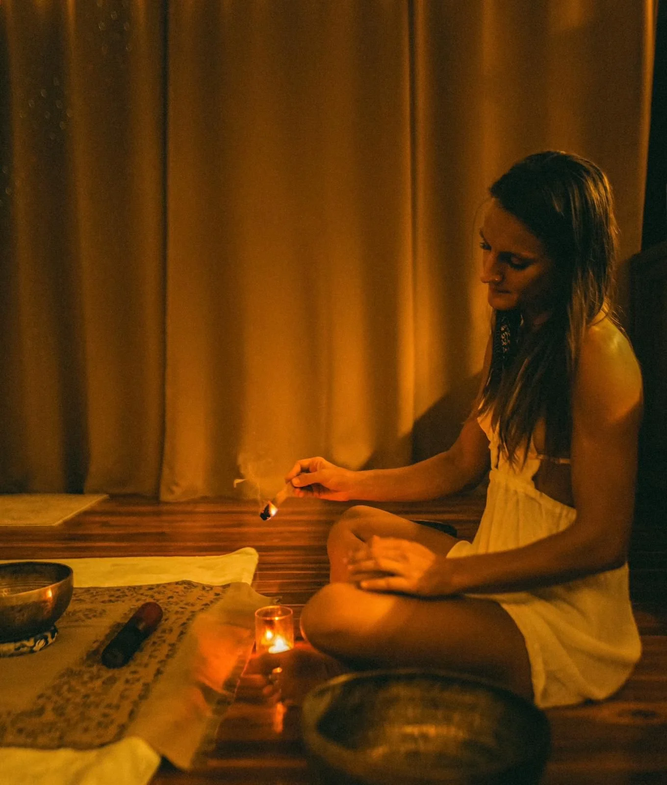 restorative yin yoga on an open-air platform in the tropics with instruments for a sound bath in the background