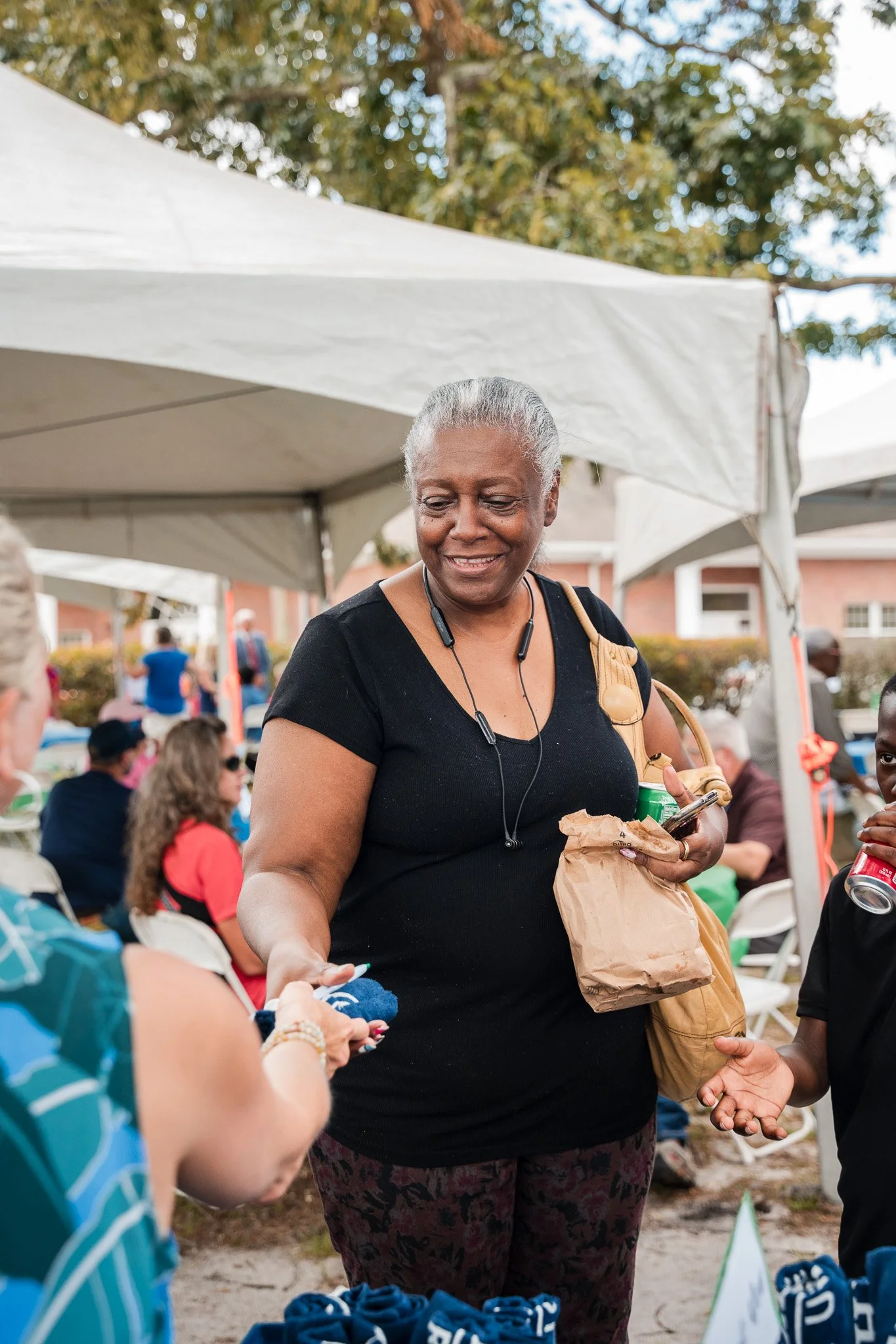Credit Union member receiving merchandise and food at Marshland event in Brunswick Georgia.