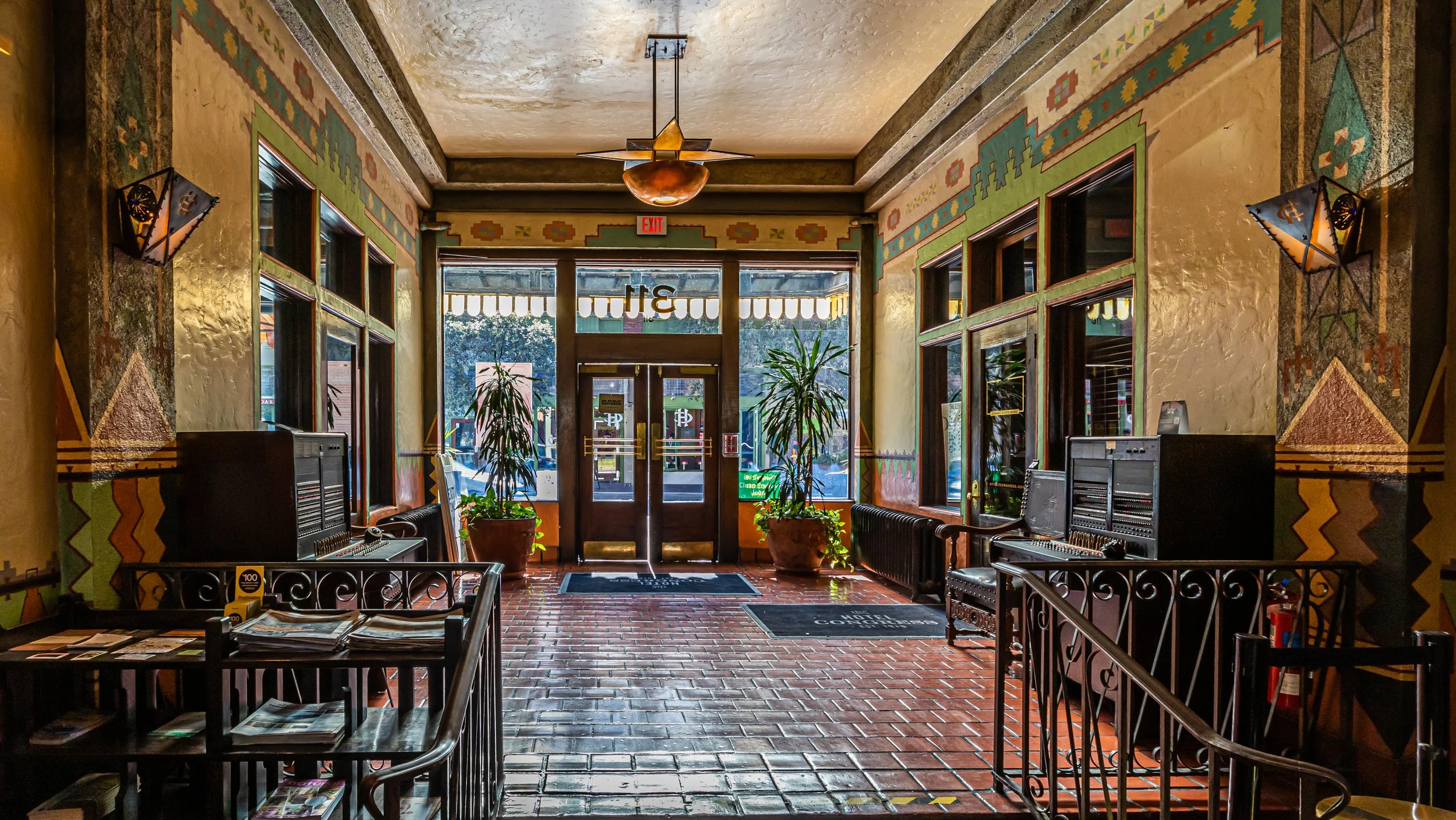 Historic Hotel Congress lobby in Downtown Tucson featuring colorful Southwestern architecture, decorative murals, brick flooring, and original early 20th-century design elements.