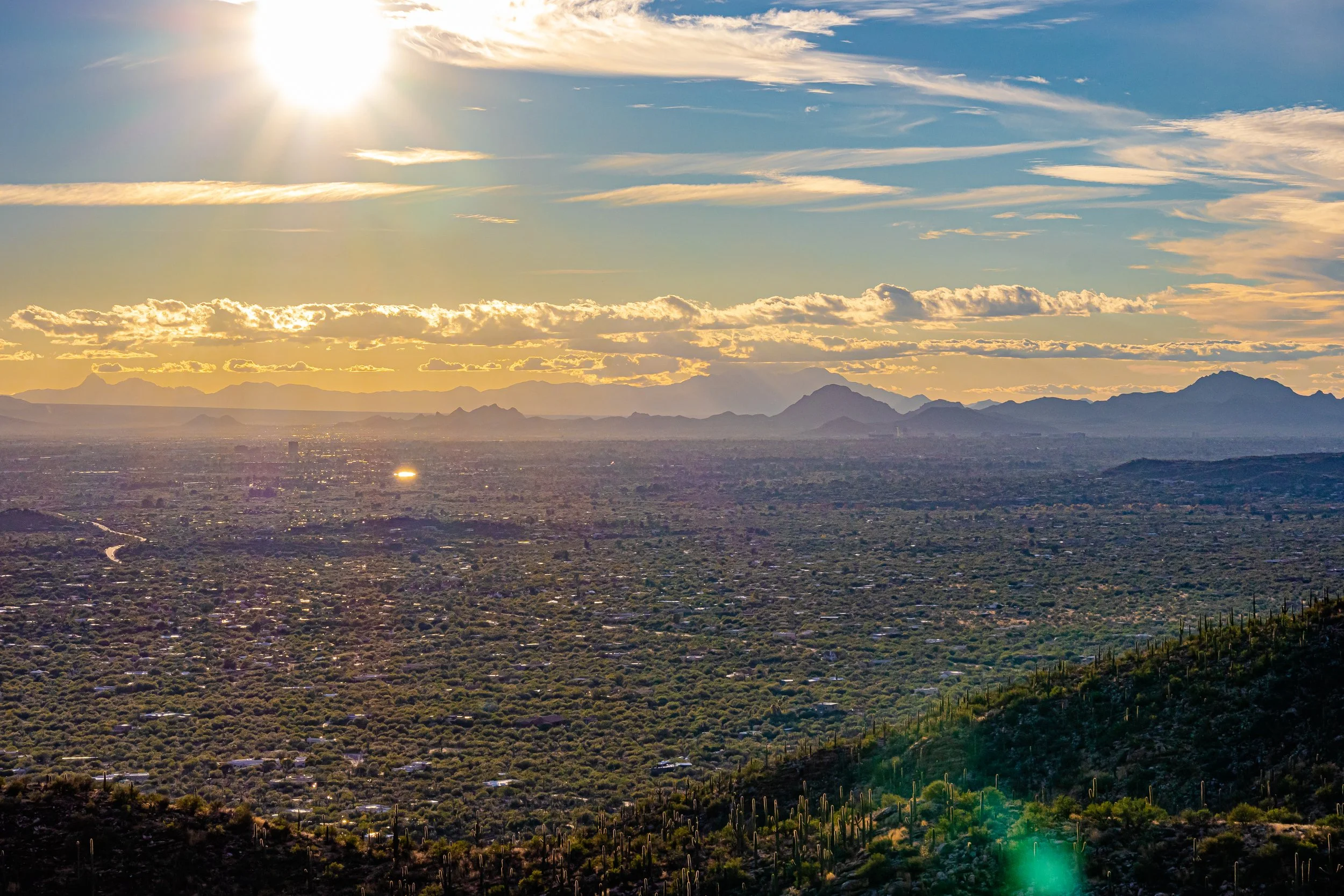 Sunrise over Tucson, Arizona with Mt. Lemmon and desert landscape, illustrating ideal morning light for healthy sun exposure.