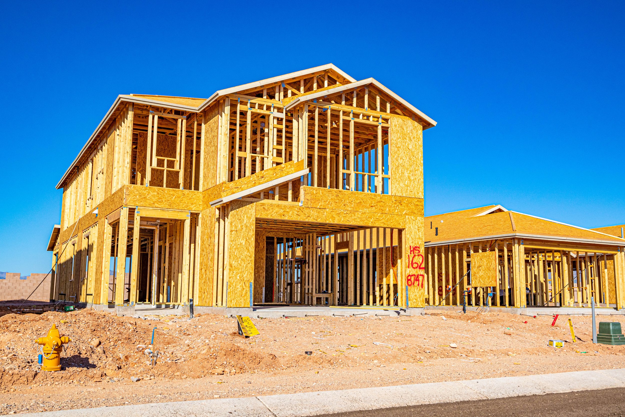 New construction homes being framed in Tucson, Arizona, showcasing ongoing residential development and homebuilding.