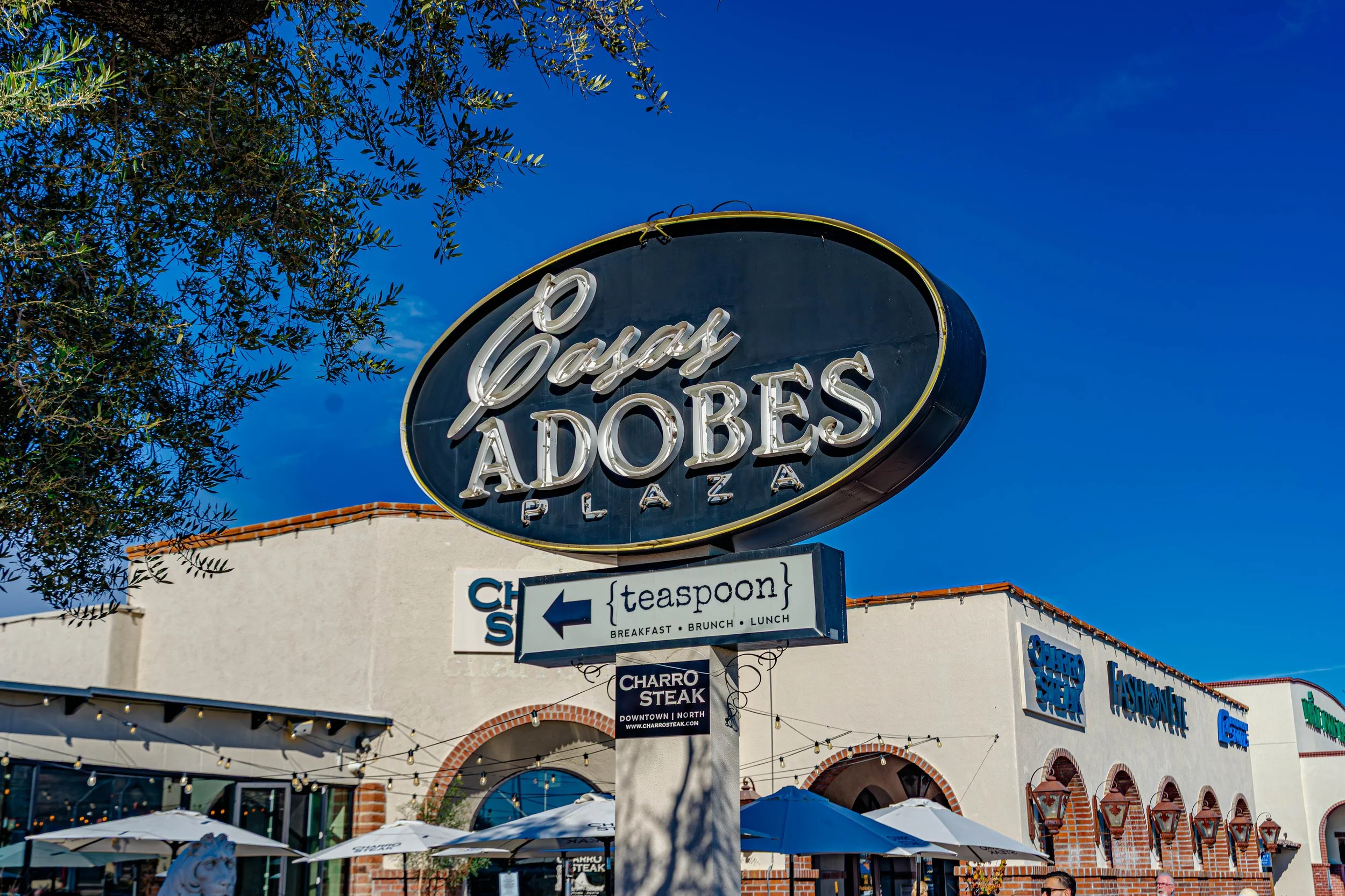 Casas Adobes Plaza shopping center in Tucson Arizona with restaurants, shops, and outdoor seating.
