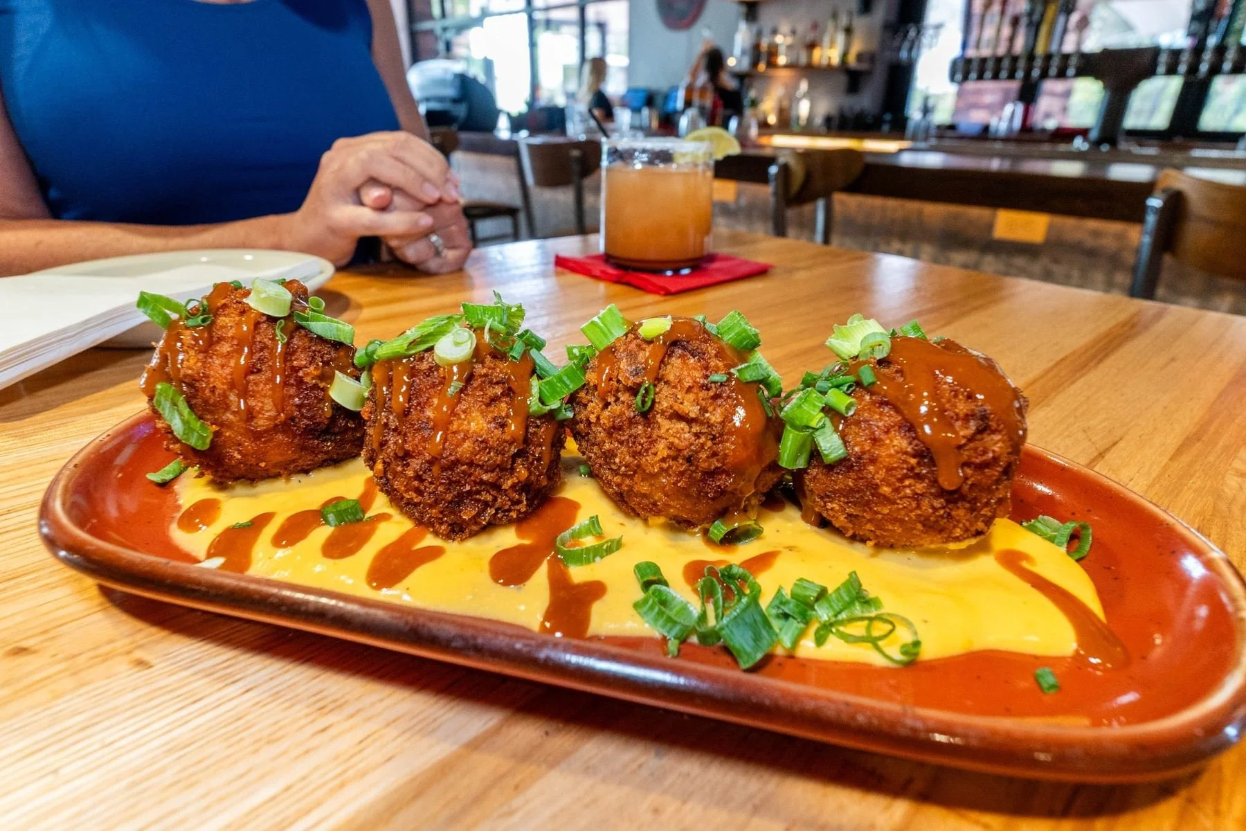 Crispy appetizers topped with sauce and green onions at Fork and Fire in Oro Valley, Arizona.