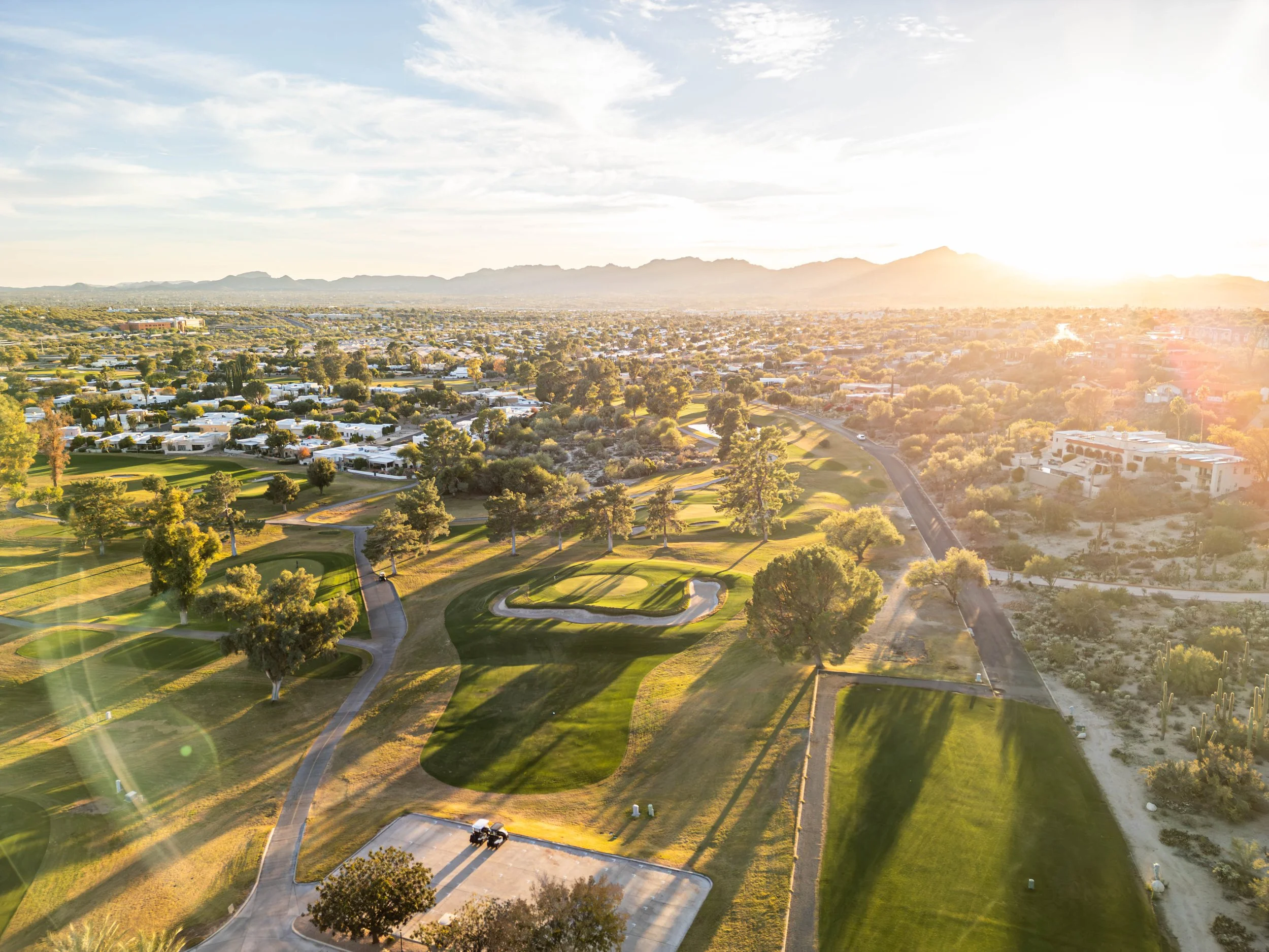 Aerial view of Casas Adobes Tucson Arizona real estate with golf course homes, desert landscape, and mountain views.