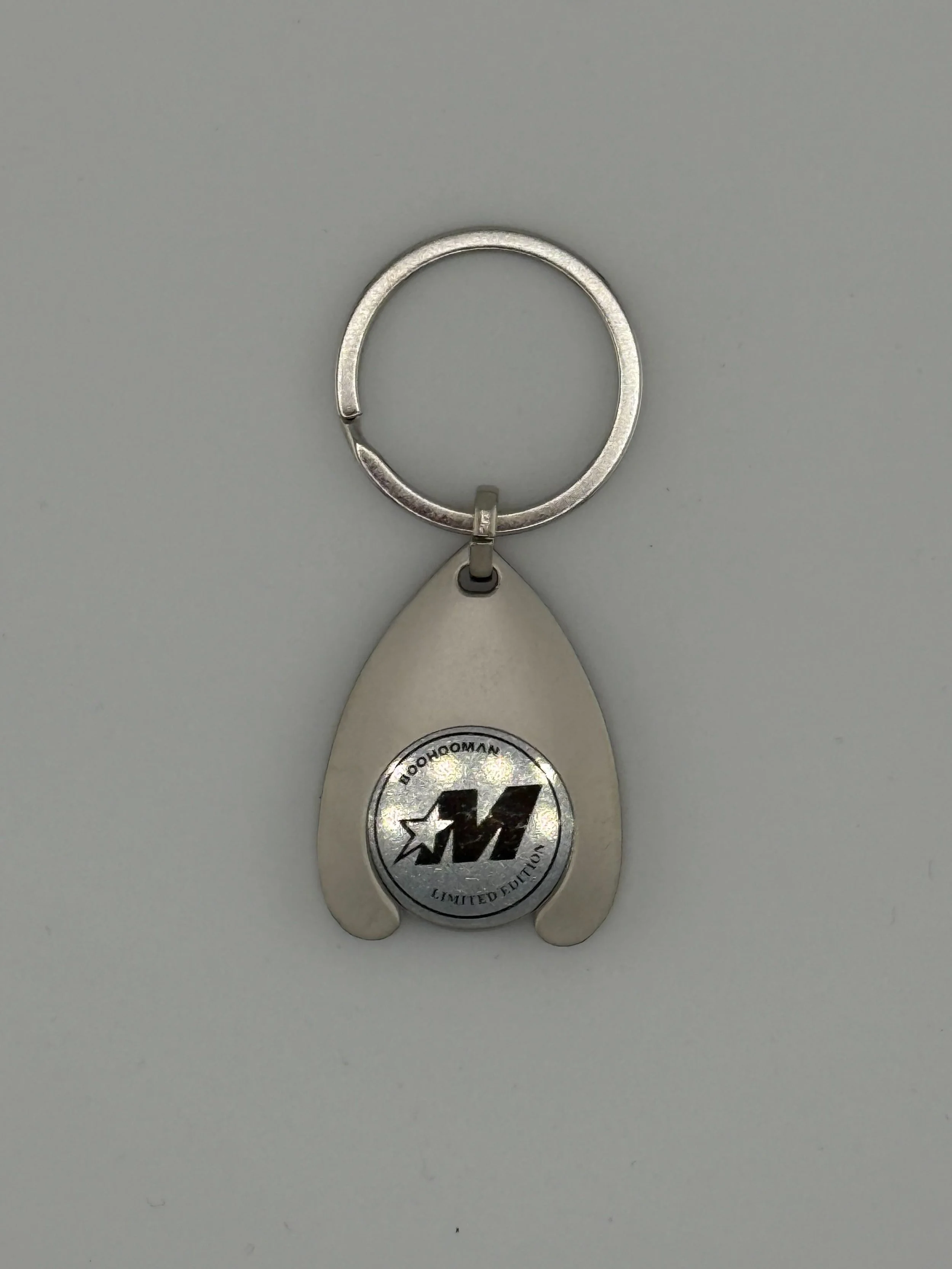 For BoohooMAN we created limited-edition metal keyrings with a custom die-struck medallion showcasing their “M” and “B” star logos. The brushed metal finish and compact shape deliver a retail-quality feel, turning a simple keyring into a collectible 