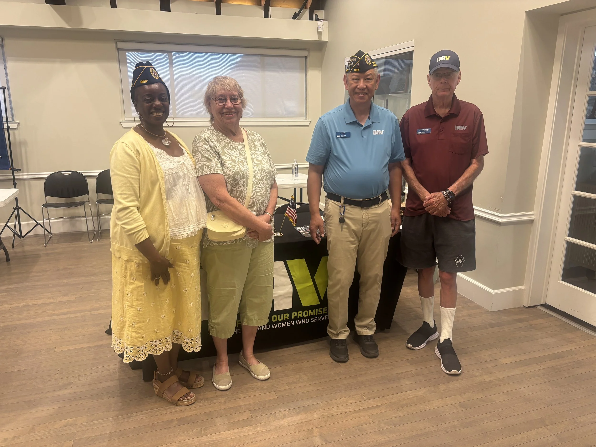 Commander Bonita Knuckles, 1st Vice Commander Mark Raymond, and Adjutant Calvin Lee talking with Nurse (Vietnam-Era Veteran) Gayle Minkler.