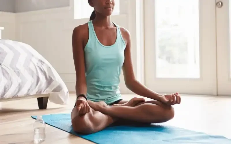 Women on yoga mat doing meditation