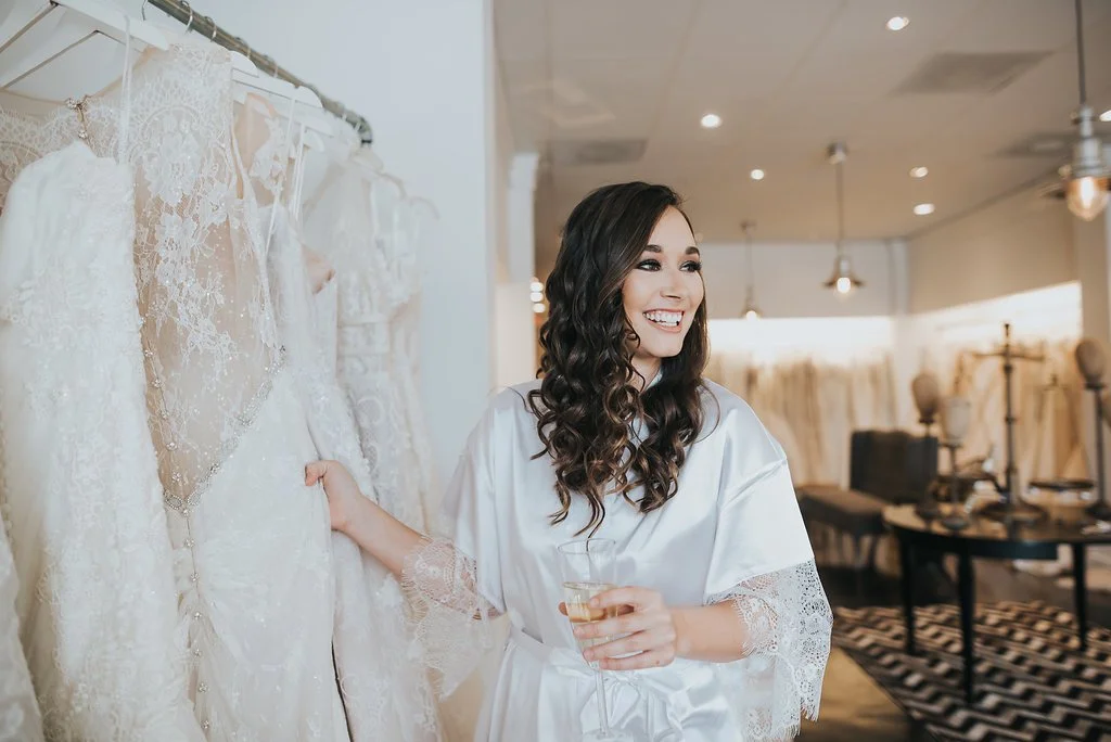 Bride shopping for off the rack wedding dress in Tampa Bridal Boutique Sample Sale