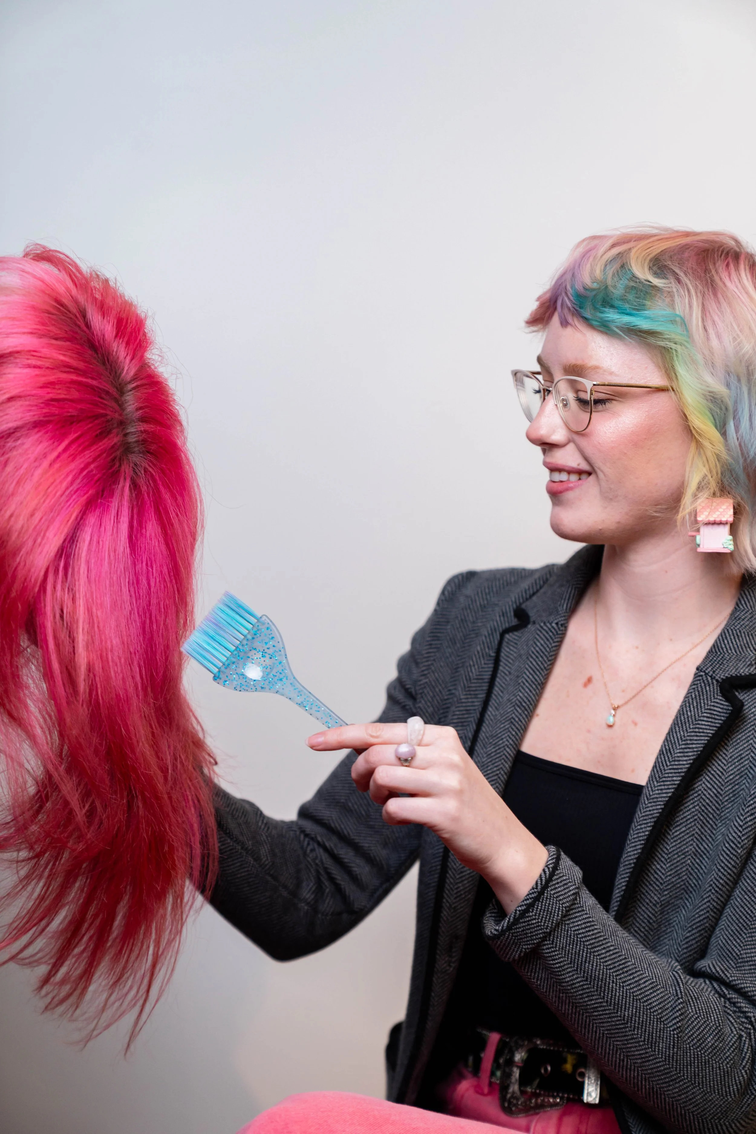 Hair stylist applying vivid fashion hair color at GROW Salon & Spa in Brookside Kansas City