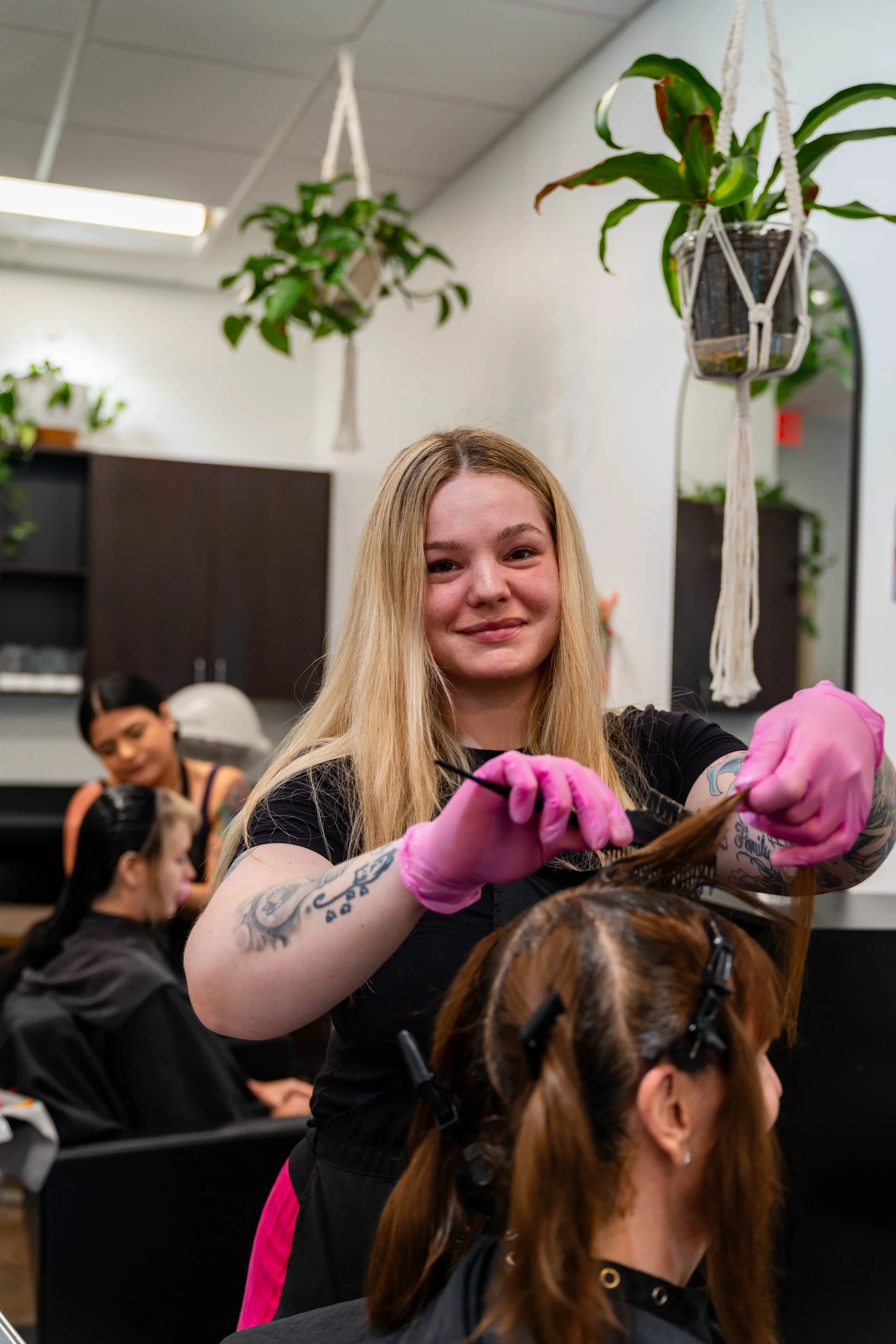 Hair stylist applying professional hair color at GROW Salon & Spa in Brookside Kansas City
