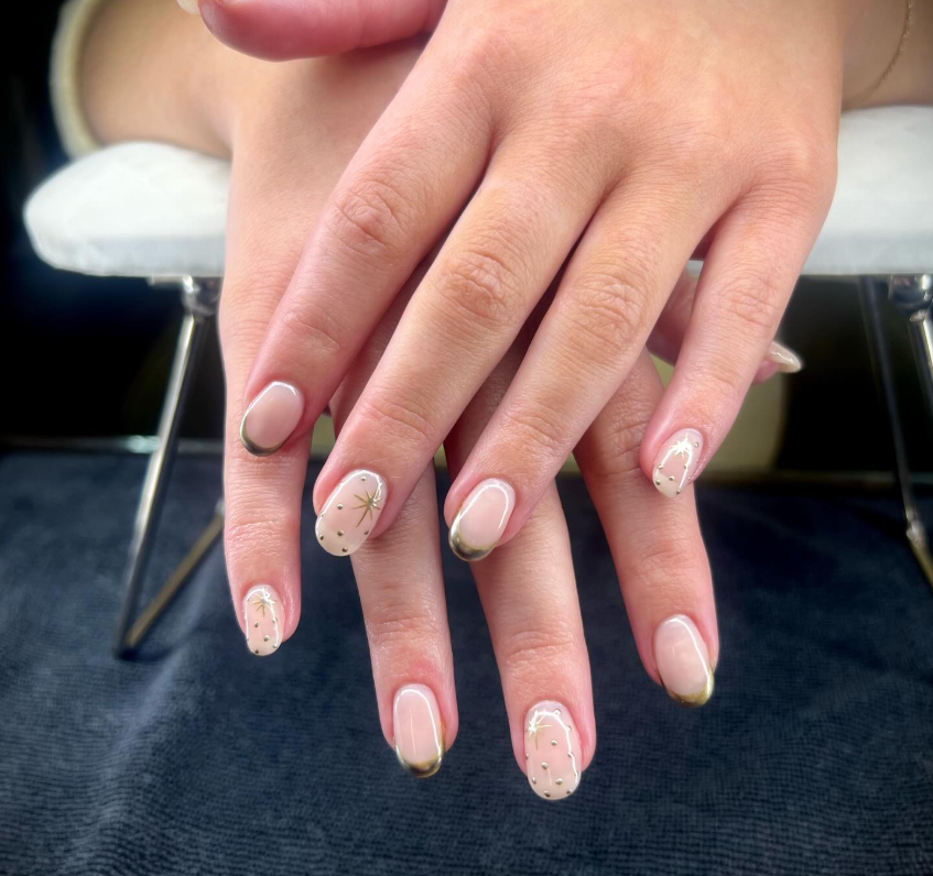 Minimalist gel manicure with subtle star nail art and soft neutral tones.