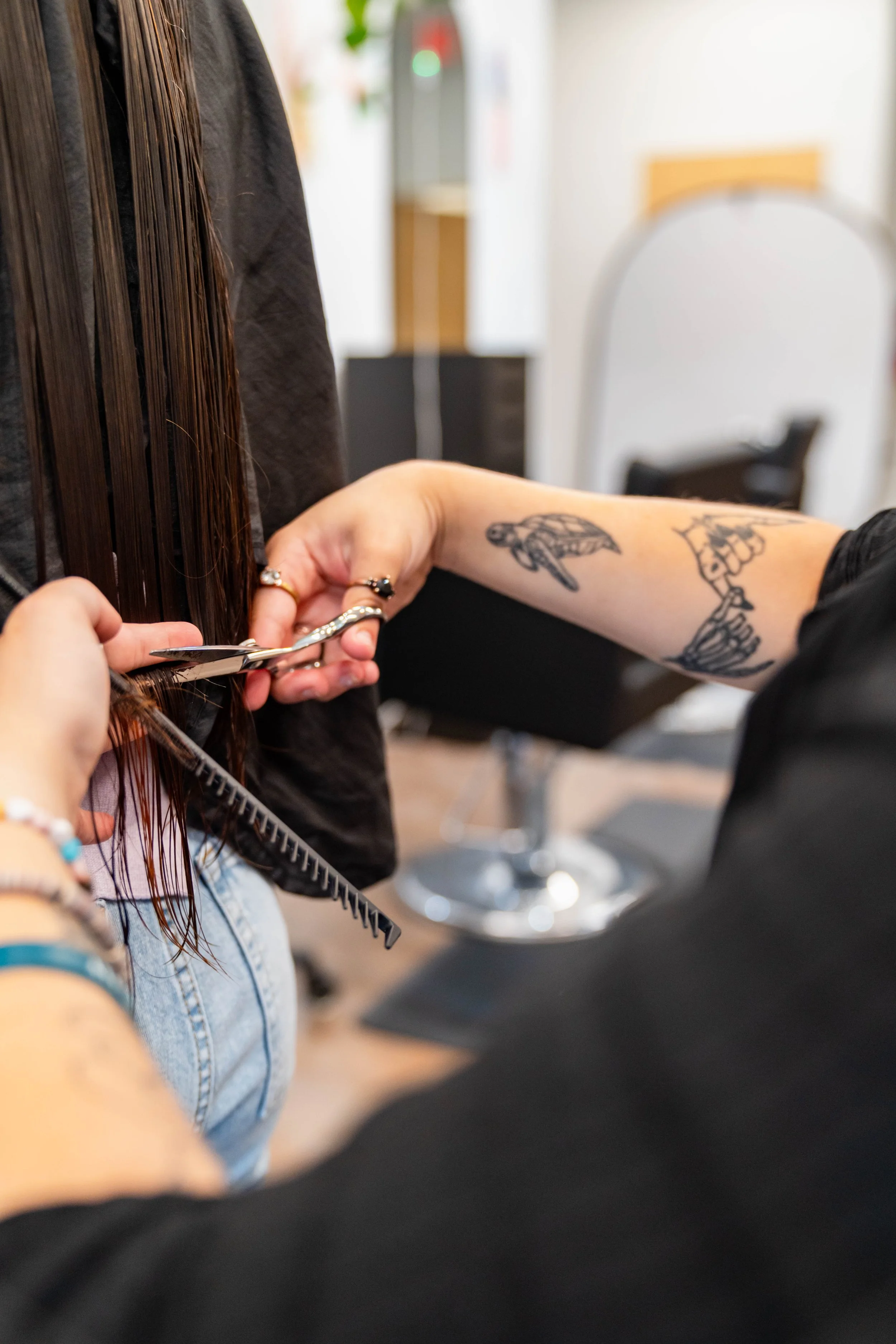 Hair stylist cutting long hair at GROW Salon & Spa in Brookside Kansas City