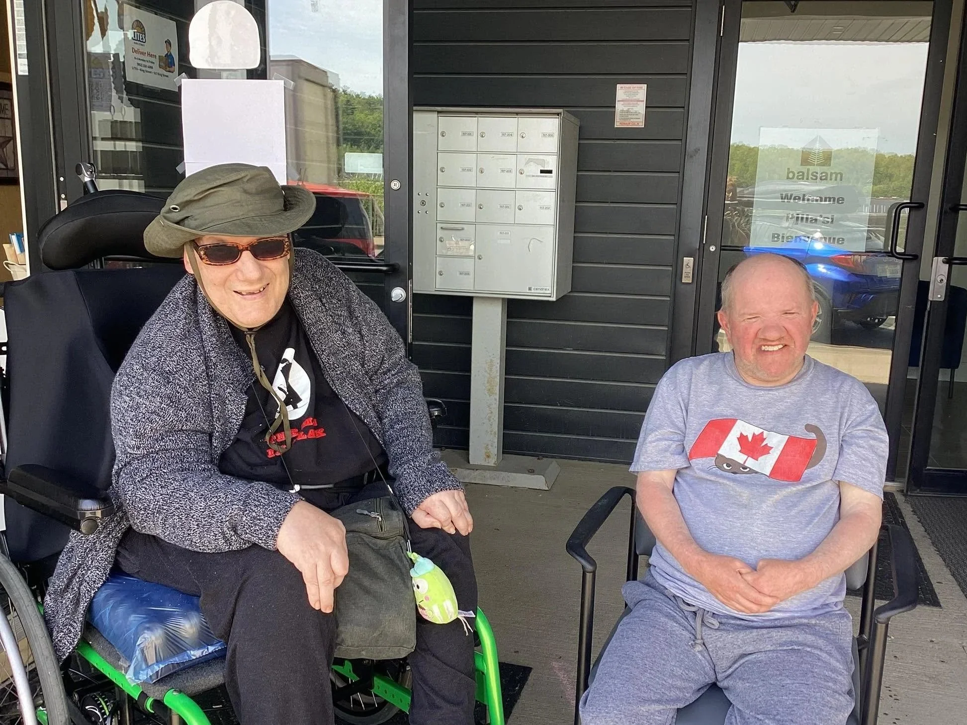 Two men sitting outside smiling