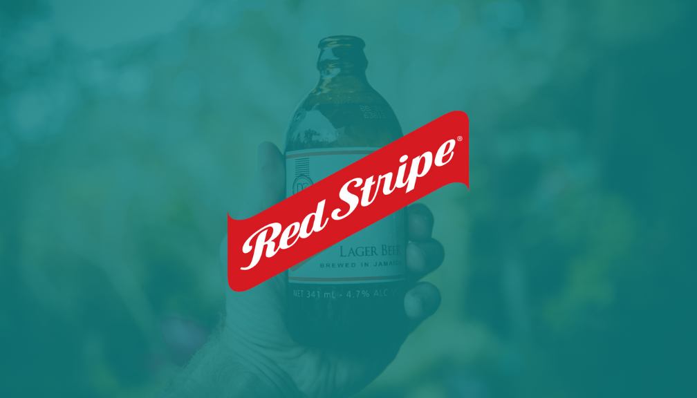 Image of Hand Holding Red Stripe Beer Bottle