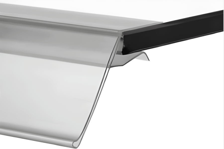 Close-up of a metal gutter with a black downspout of a retail display shelf or rack.