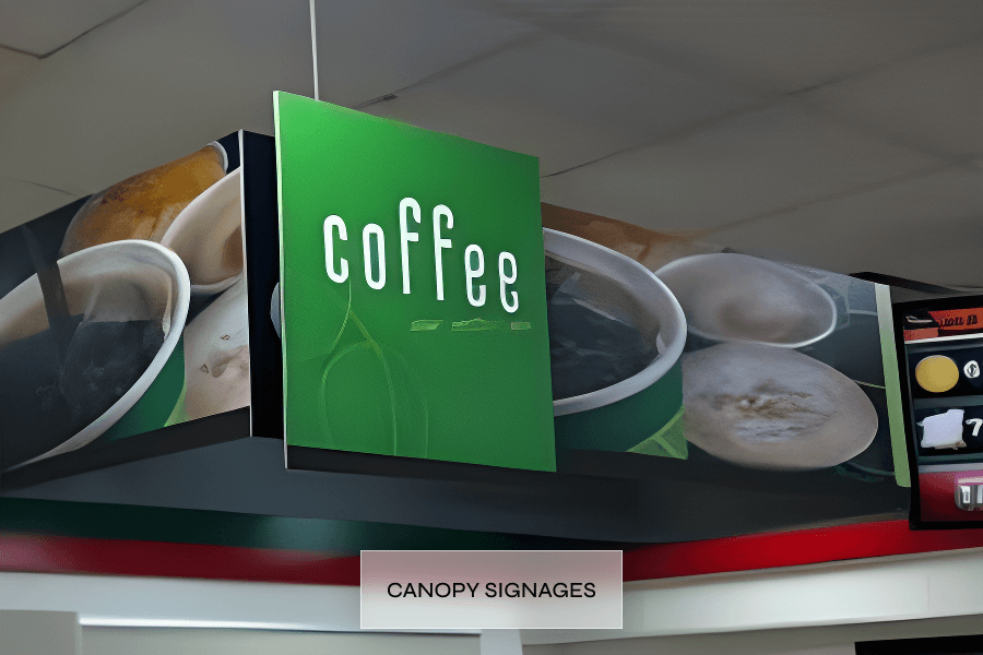A green canopy sign with the word 'coffee' in white letters above images of various coffee drinks like cups of black coffee and cappuccinos at a cafe or convenience store.