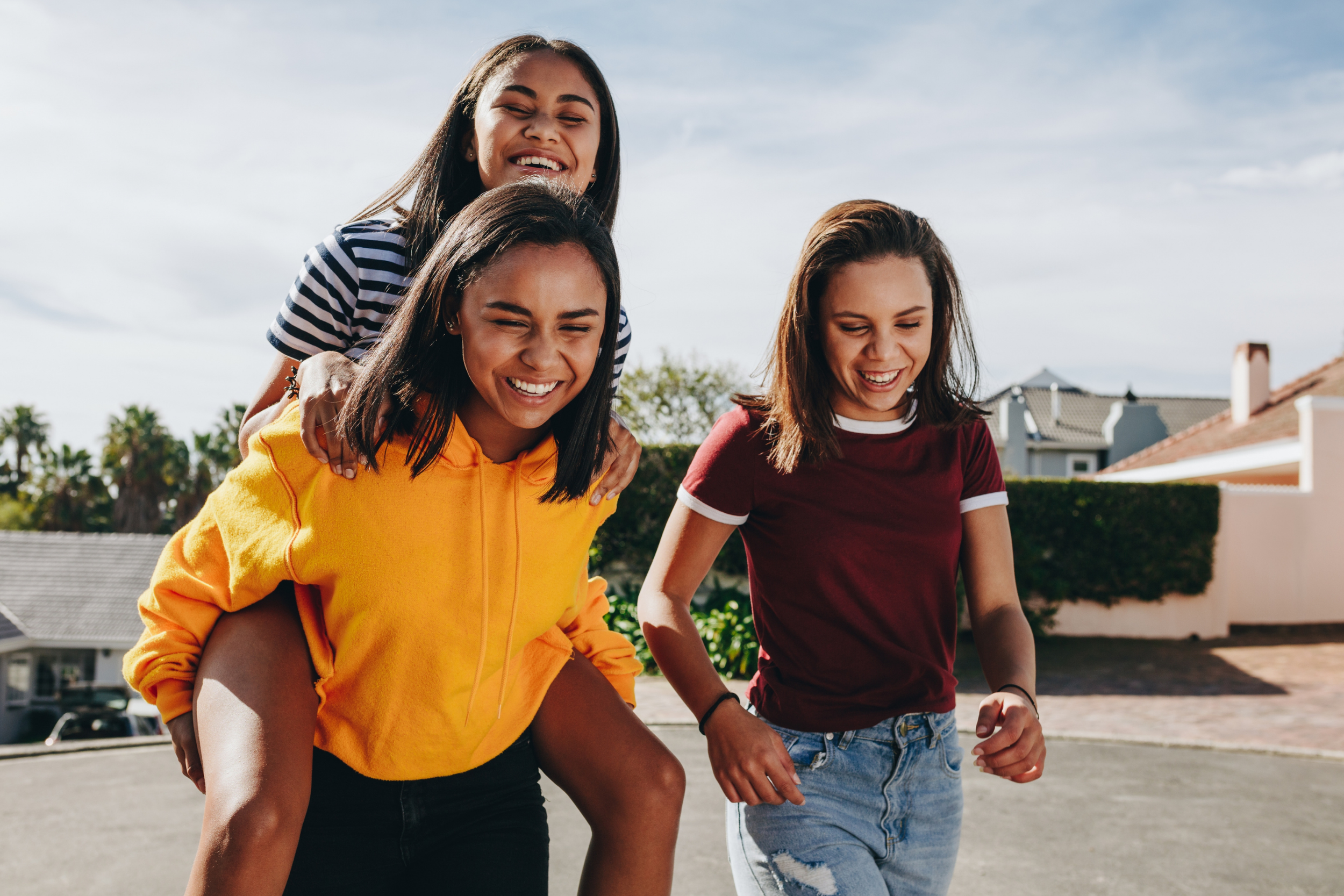 group of three girls smiling and having fun together