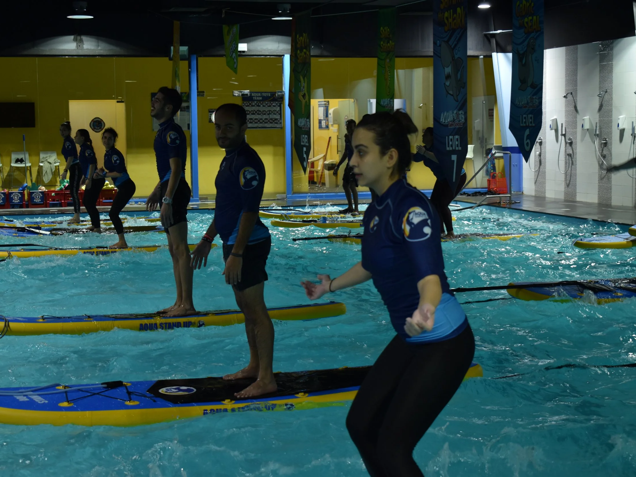 AQUA STAND UP® instructors standing up on their boards during an AQUA STAND UP® session