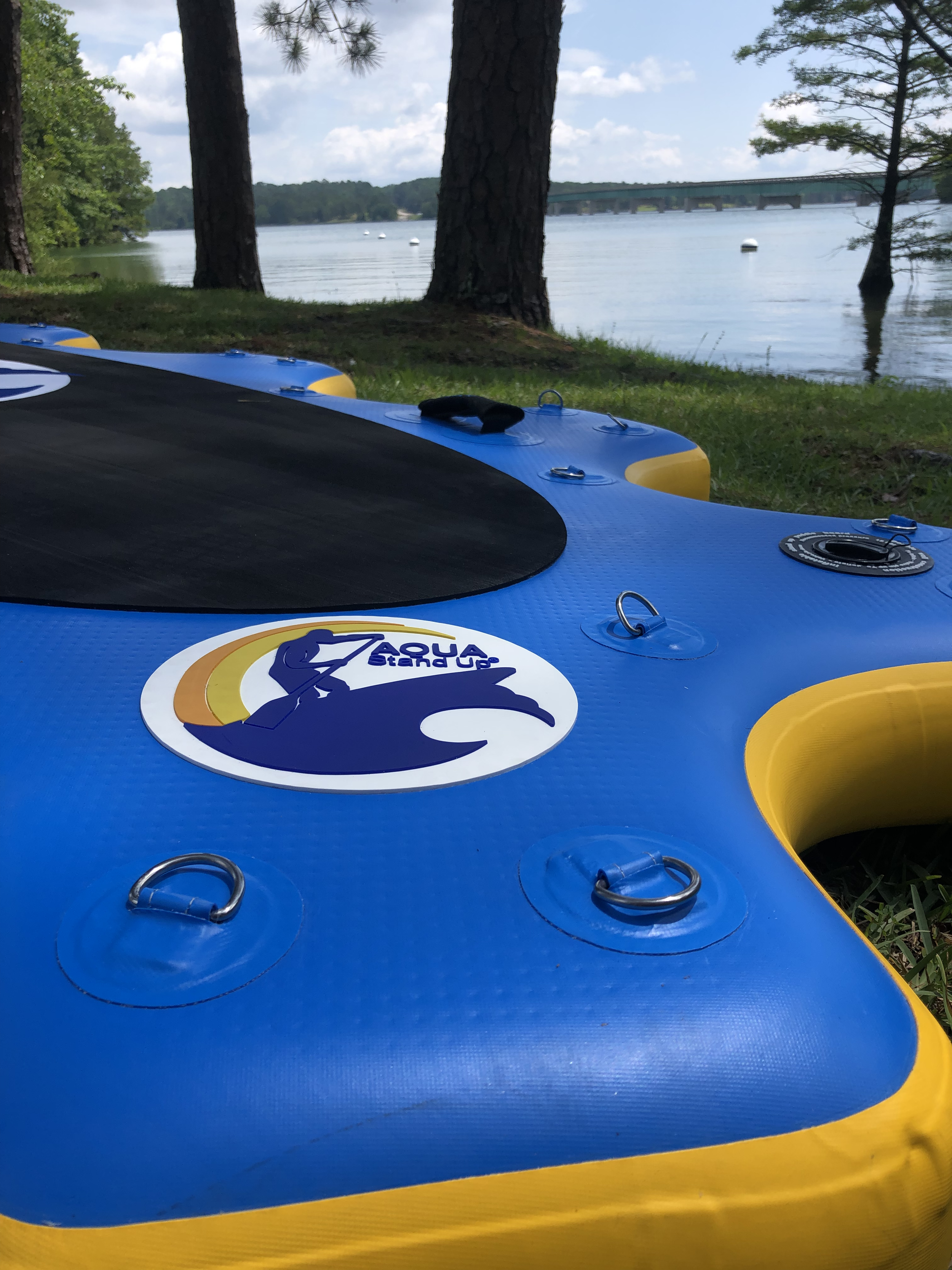 close up on an inflatbale platform aquastandup with a view on a lake