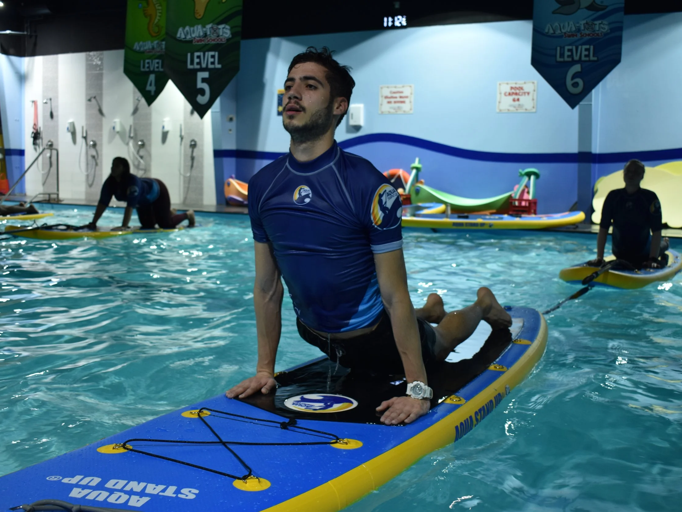 aquastandup instructor performing up dog pose during an AQUA STAND UP® class