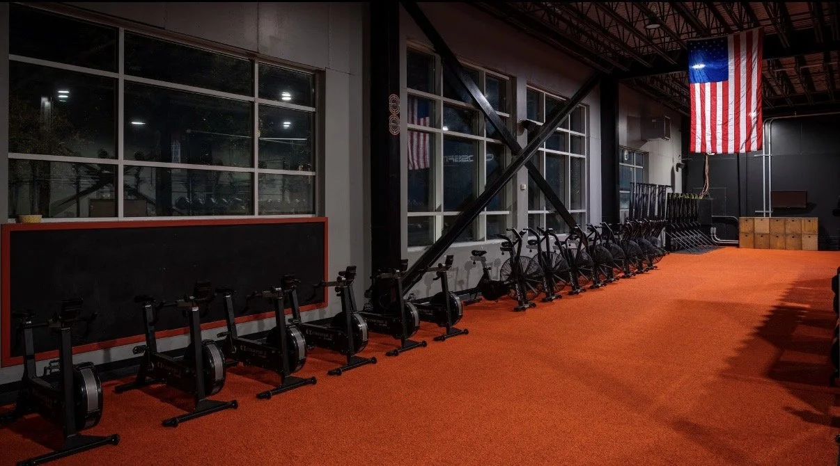 CrossFit gym bikes and training floor at QC Fit West Charlotte NC.