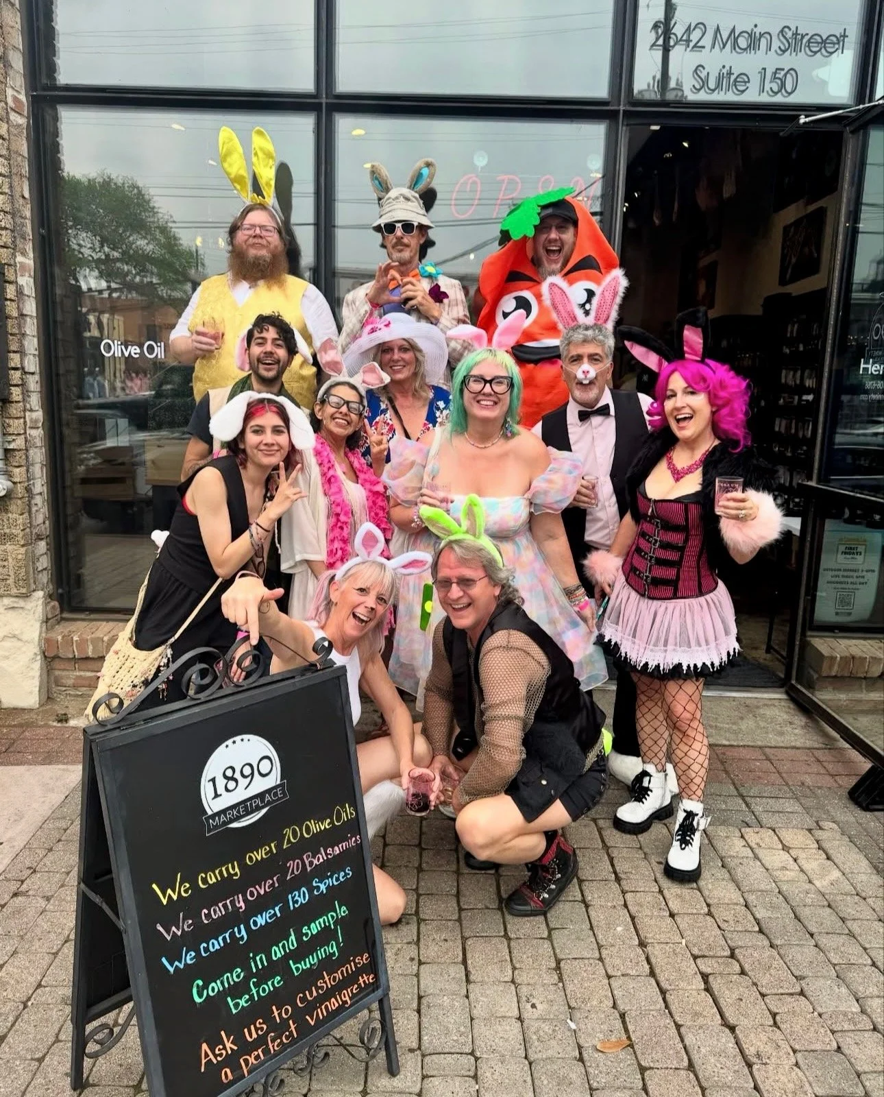People dressed in costumes and colorful outfits outside a store, enjoying the Deep Ellum Wine Walk.