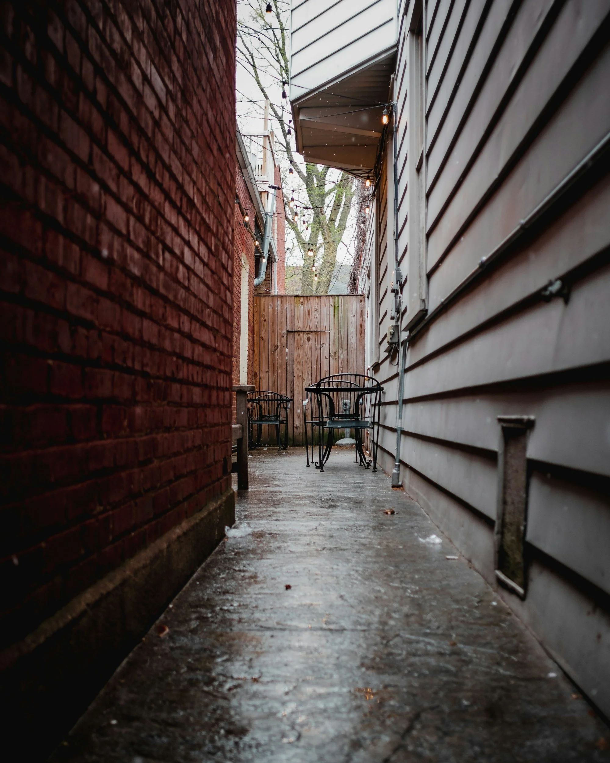 Siding in between two houses on a rainy day