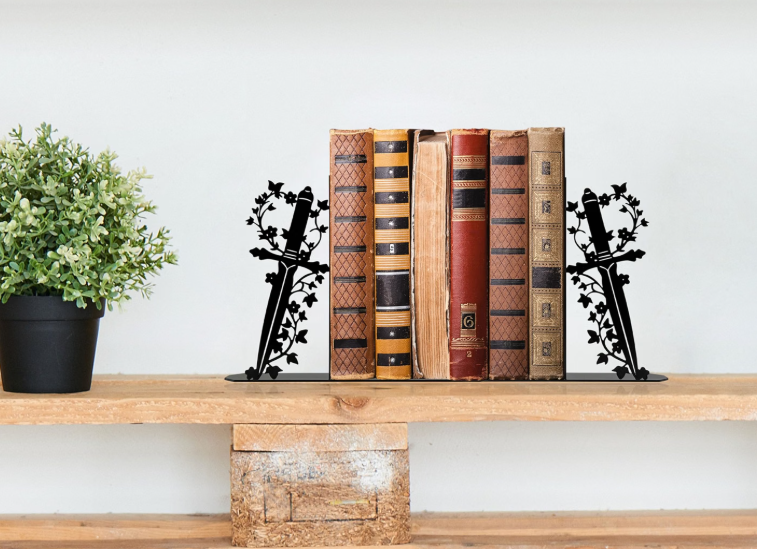 Shelf with potted plant and a row of vintage hardcover books supported by decorative black metal bookends.