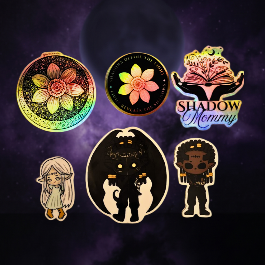 Collection of holographic stickers on a dark, cosmic background. The stickers include a flower design with intricate details, a round sticker with a flower and the text "Shadow Mommy," another with a layered book, a female elf character with long hair and pointed ears, a black cartoon dragon or demon with glowing eyes, and a dark-skinned character with curly hair, earrings, and traditional accessories.