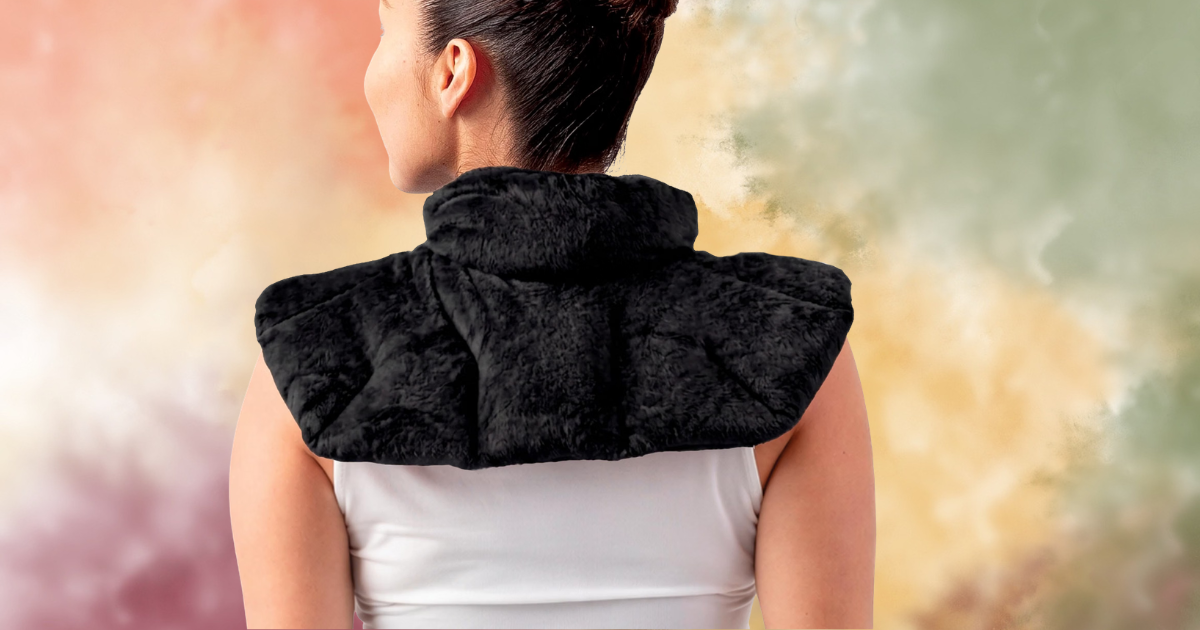 Back view of a woman wearing a sleeveless top and a black fur shawl draped over her shoulders, with a blurred pastel-colored background.