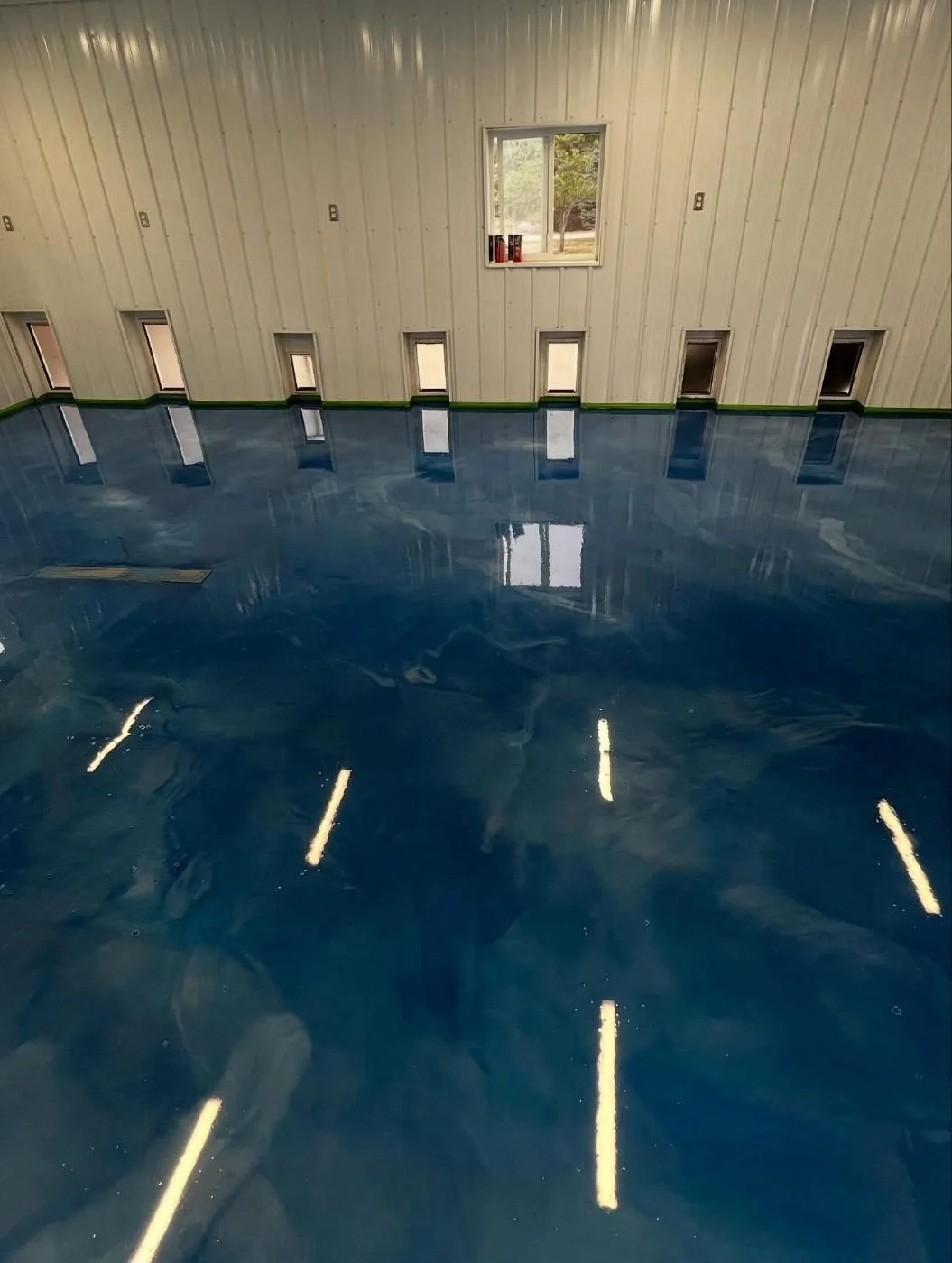 Blue metallic epoxy floor in a pole barn, installed by J&G Epoxy Coatings